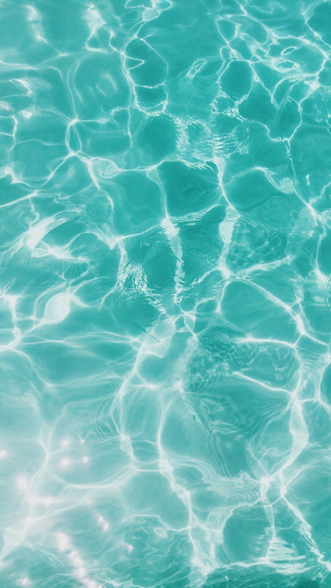 A close up of crystal clear blue water in a pool - Aqua