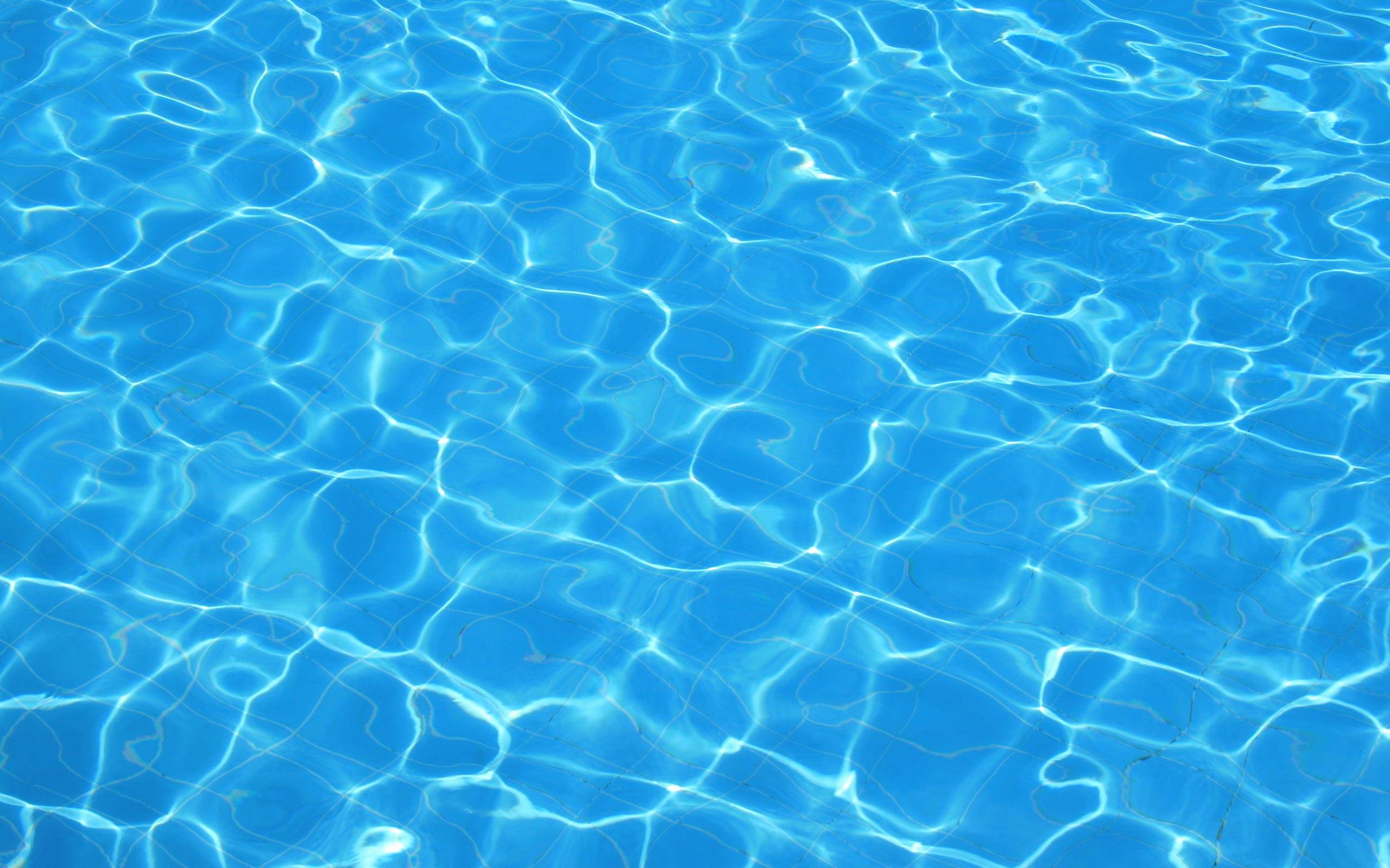 The surface of a swimming pool with light reflecting off the water - Aqua, swimming pool