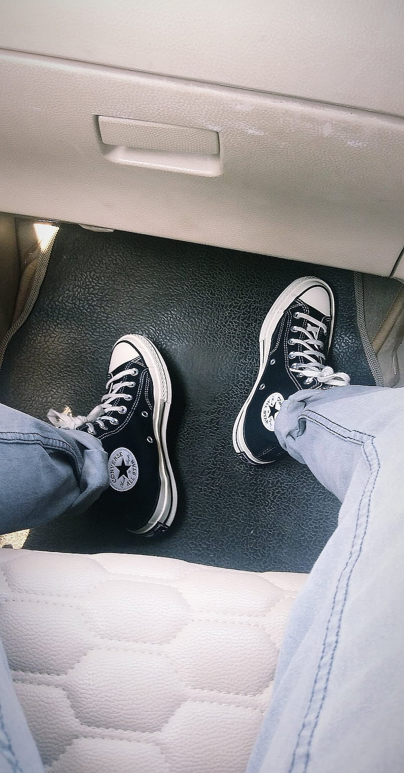 A person sitting in the back seat of their car - Converse