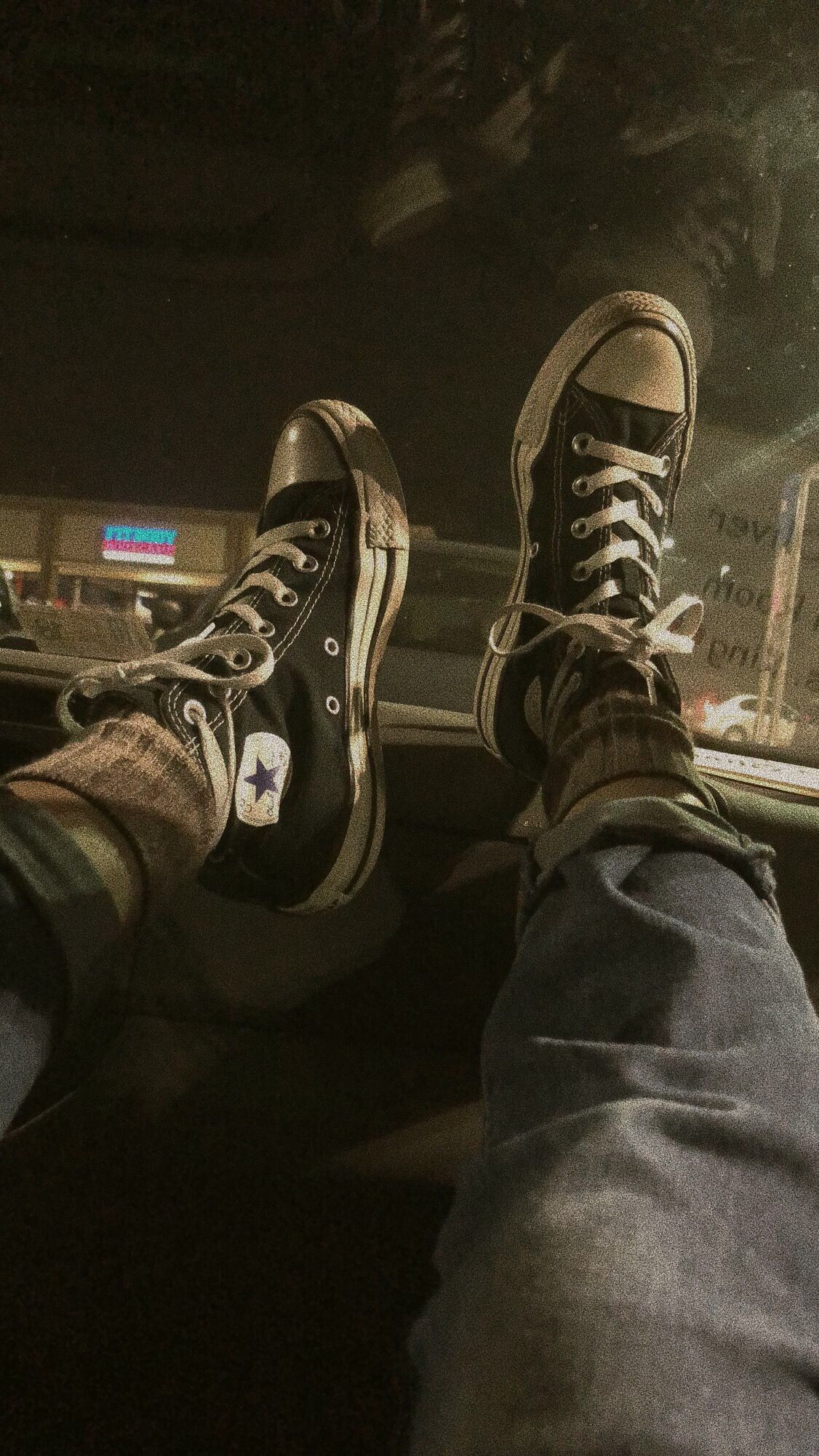 A person sitting in the back seat of car - Converse