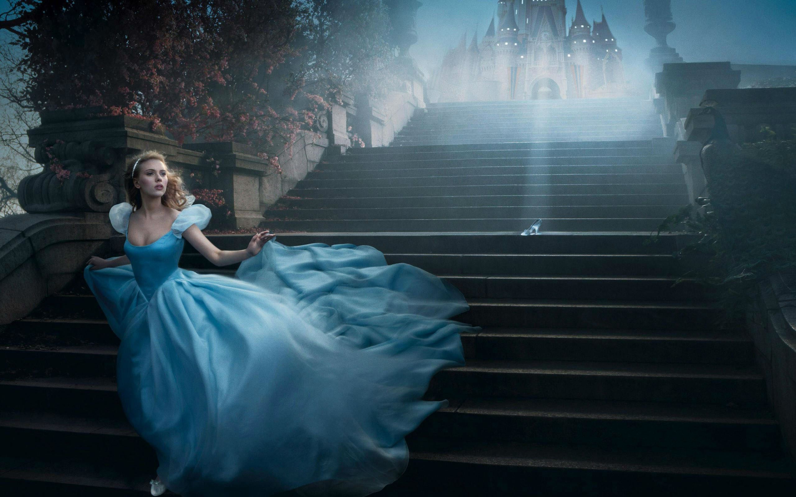 A woman in blue dress walking down stairs - 