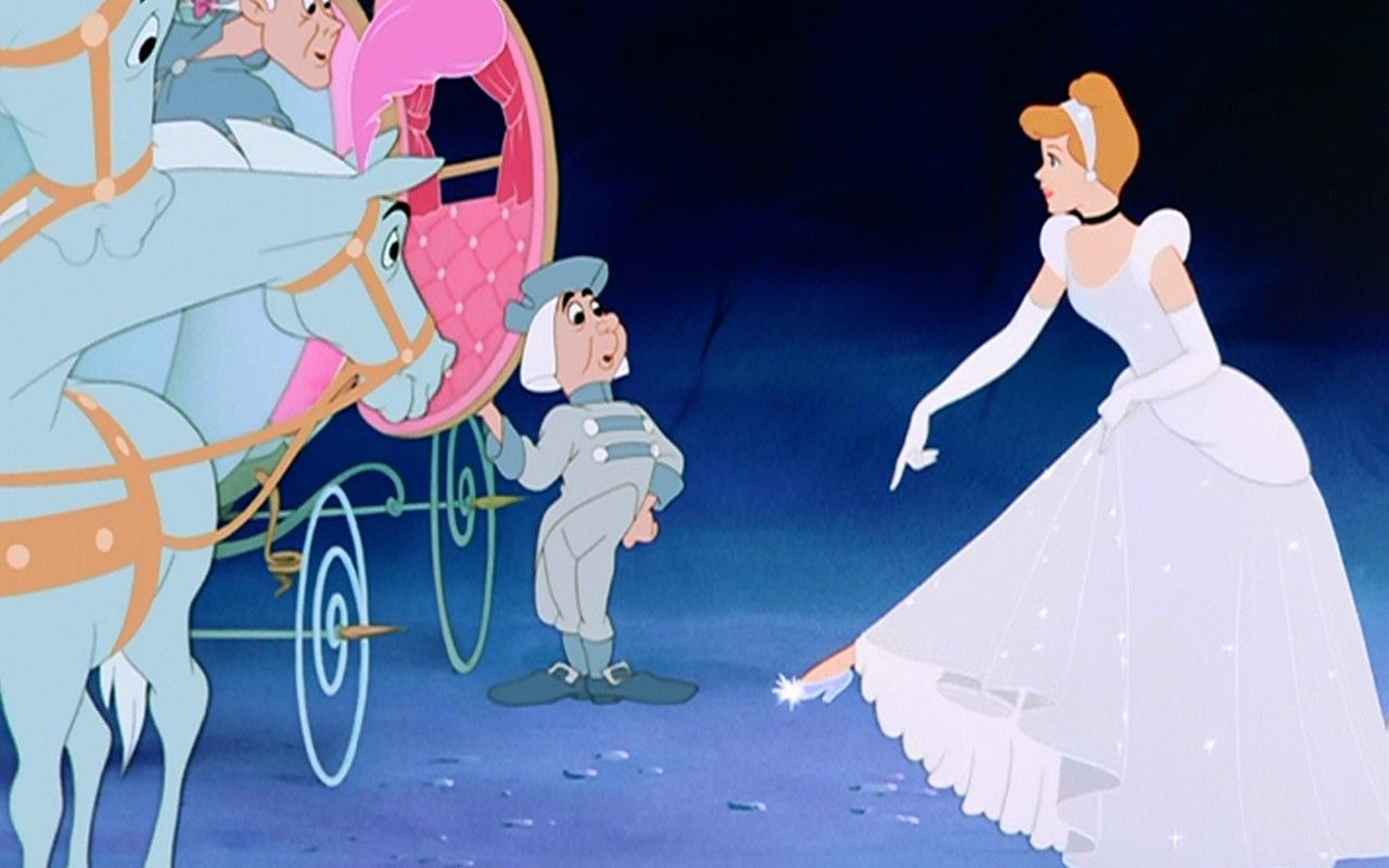 The fairy godmother waves goodbye to Cinderella as she rides away in her carriage. - 