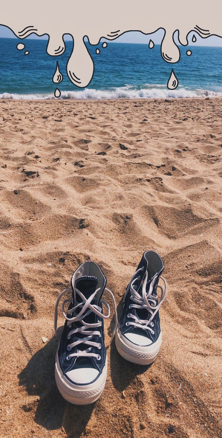 A pair of shoes on the beach - Converse