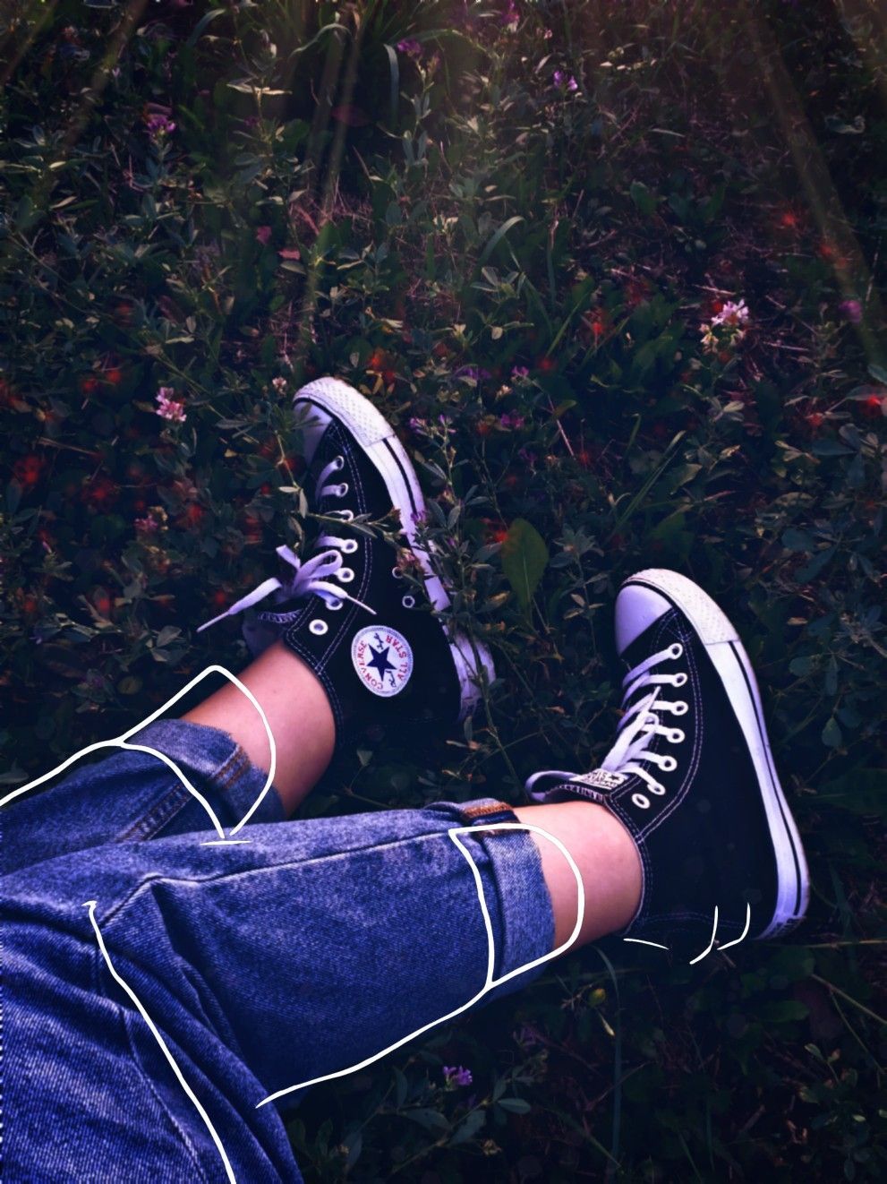 Black converse sneakers on a person's legs - Converse