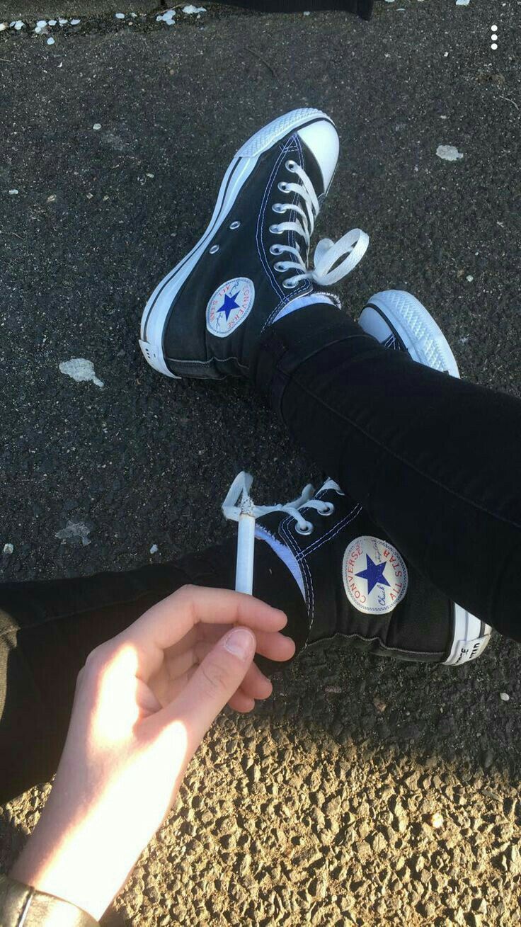 Black converse with white laces and a white star on the side - Converse