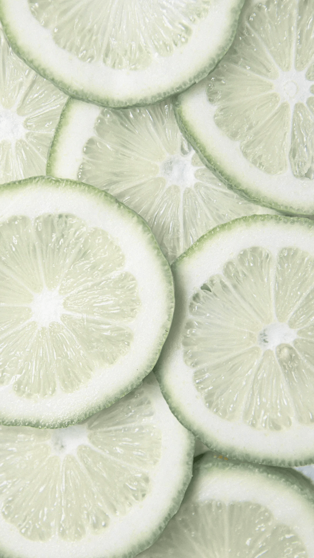 A close up of a pile of sliced limes. - Cute white, sage green, lime green