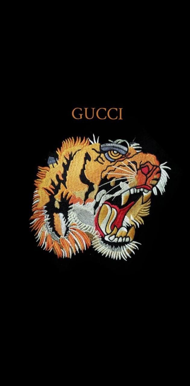 A black Gucci wallpaper with a tiger head in the middle - Gucci