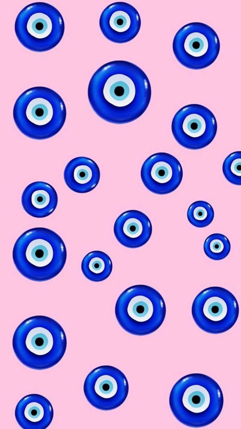 A pattern of evil eyes on pink background - Eyes