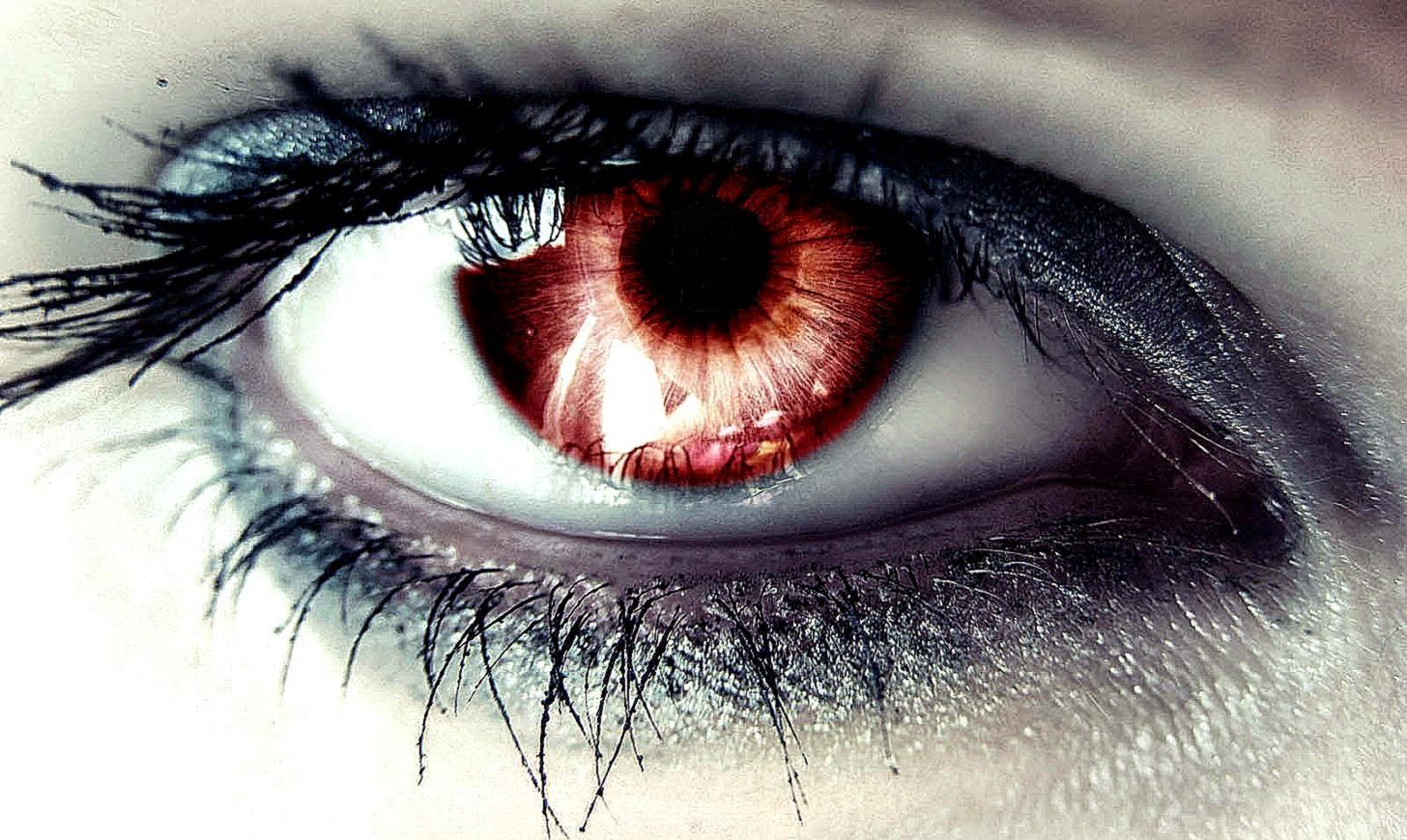 A close up of a person's eye with red irises - Eyes