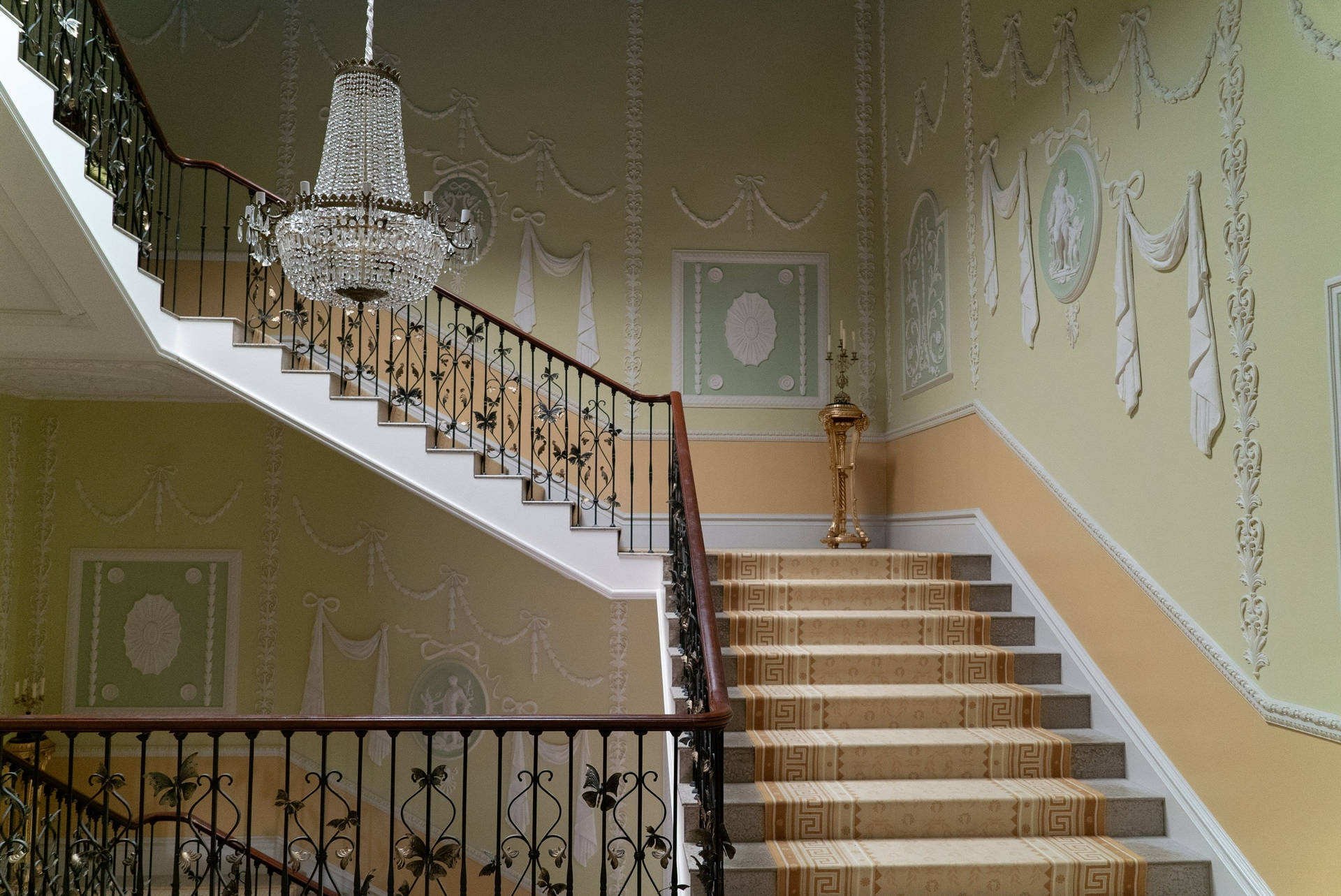 A staircase with carpet and railings - Bridgerton