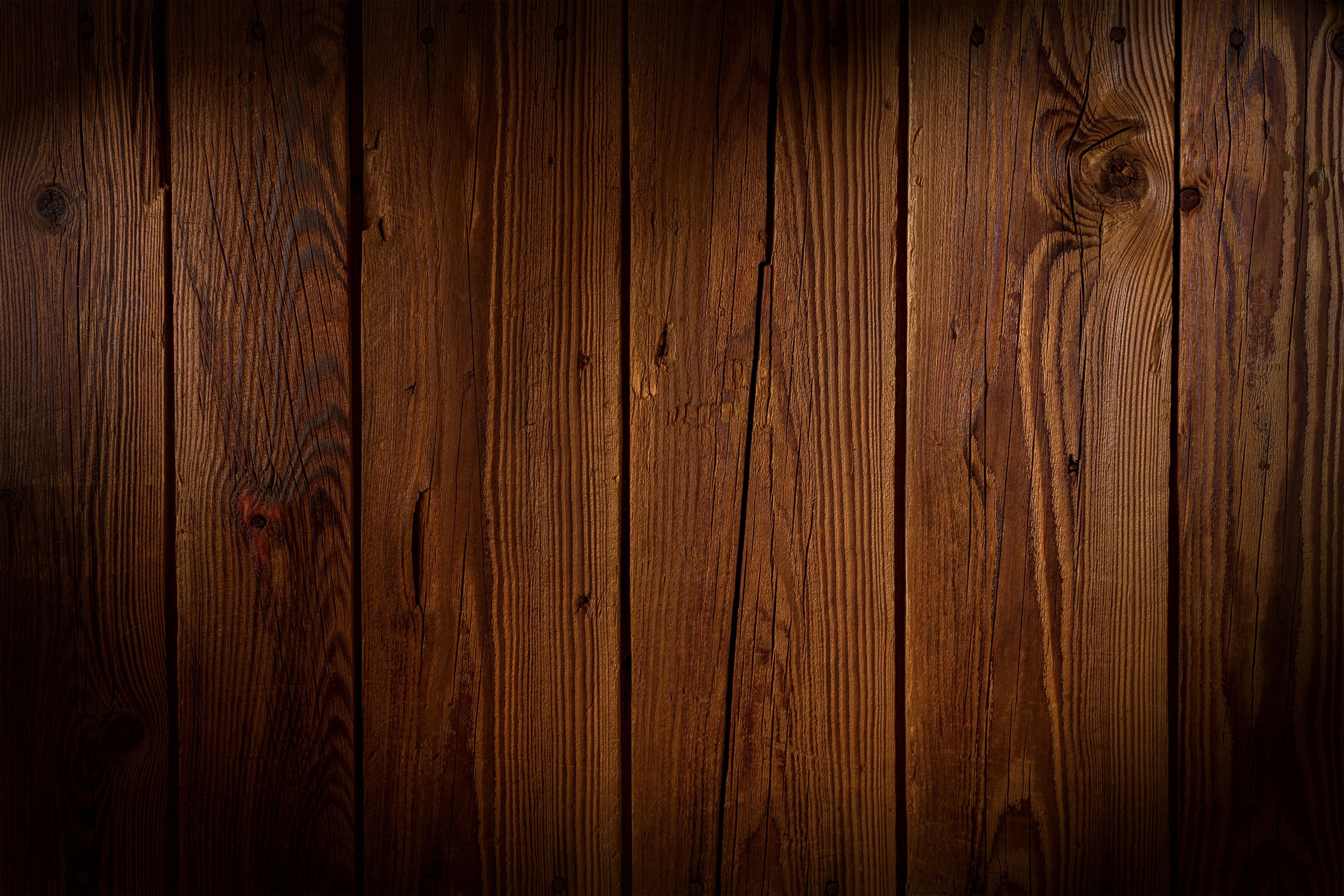 A wooden wall with light shining through it - Woods