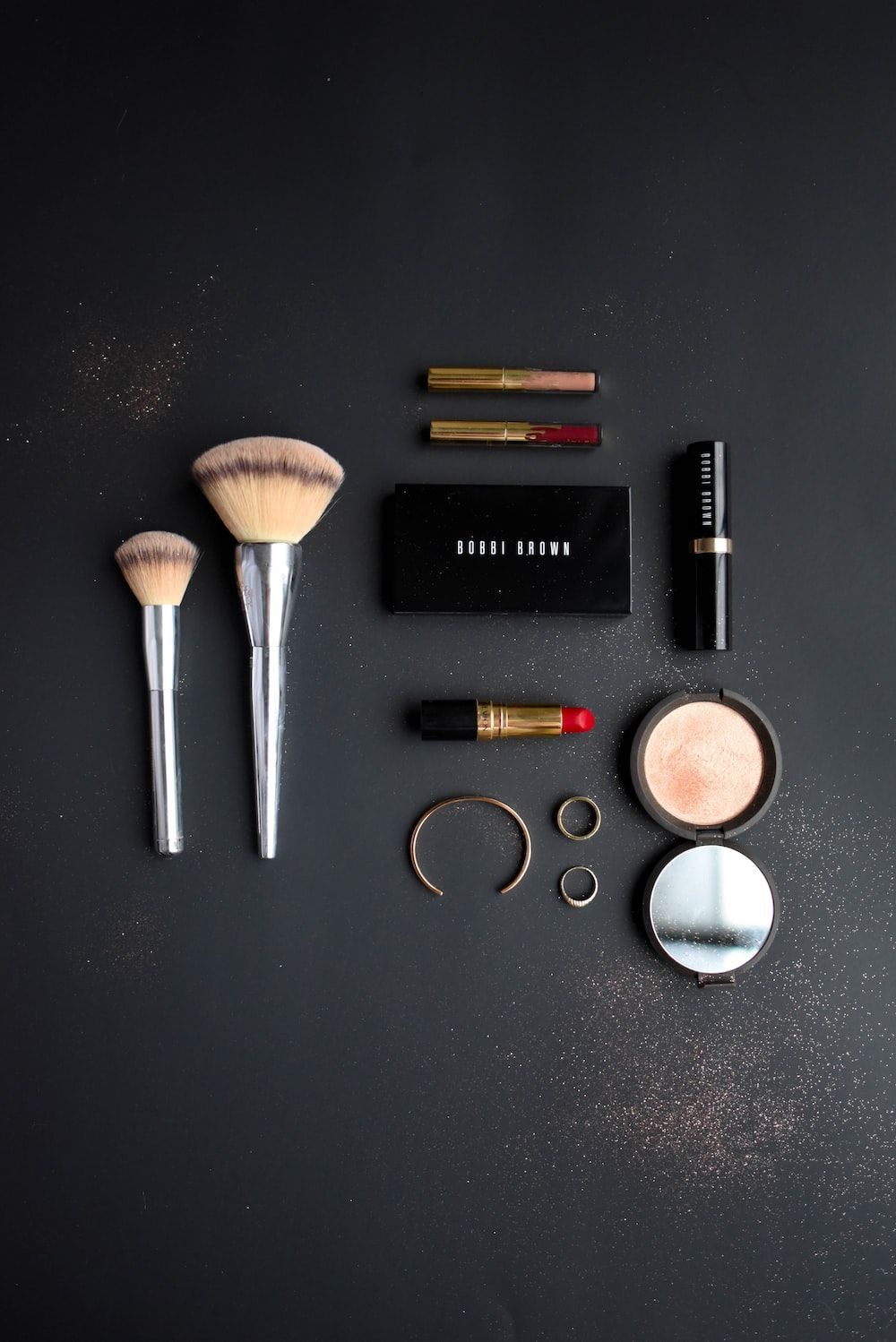 A collection of makeup on a black background - Makeup