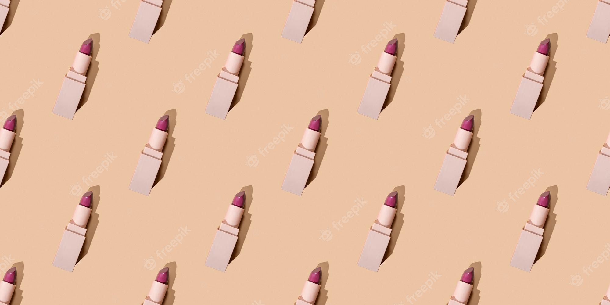 Pattern of pink lipsticks on a beige background - Makeup