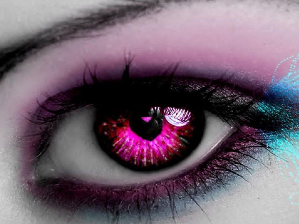 A close up of an eye with pink and purple makeup - Eyes