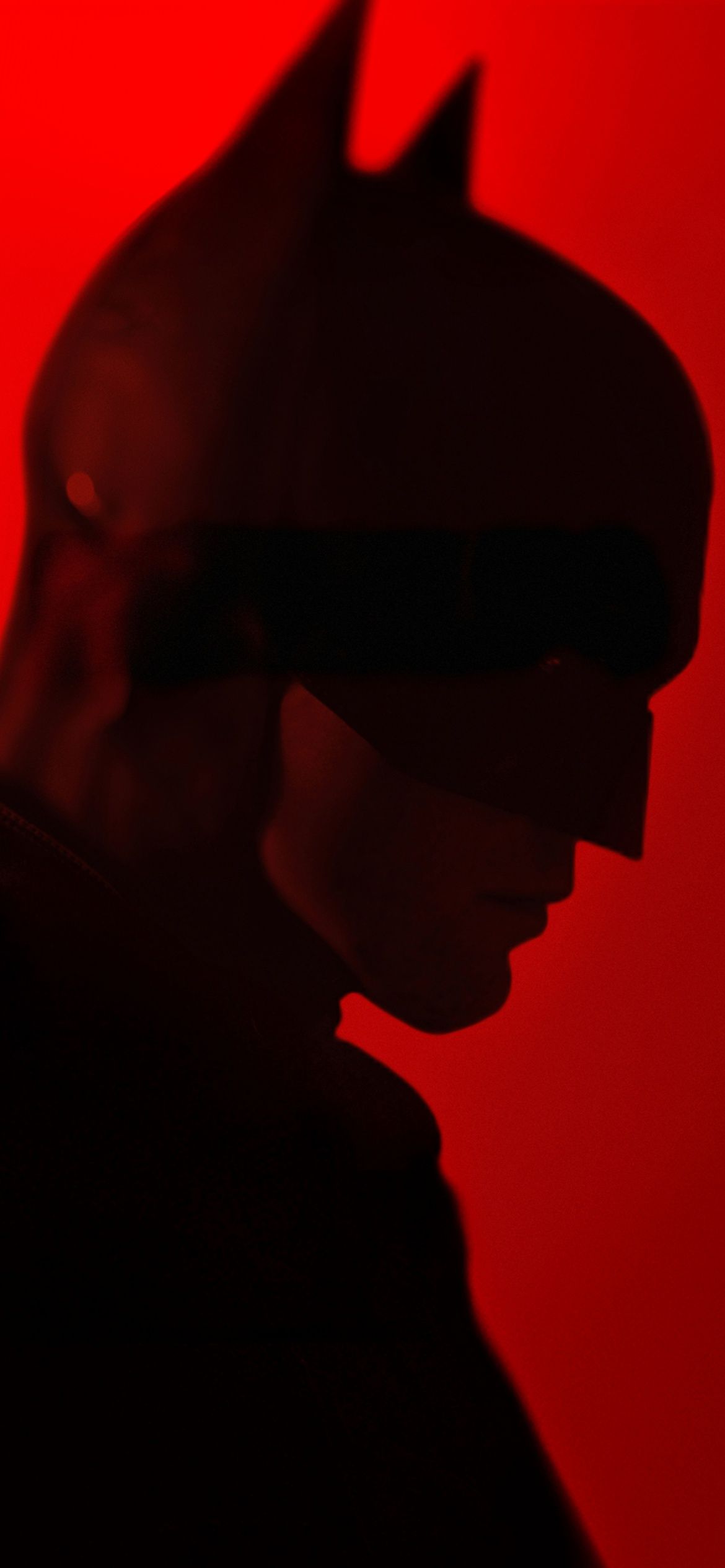 A batman in silhouette against red background - Batman