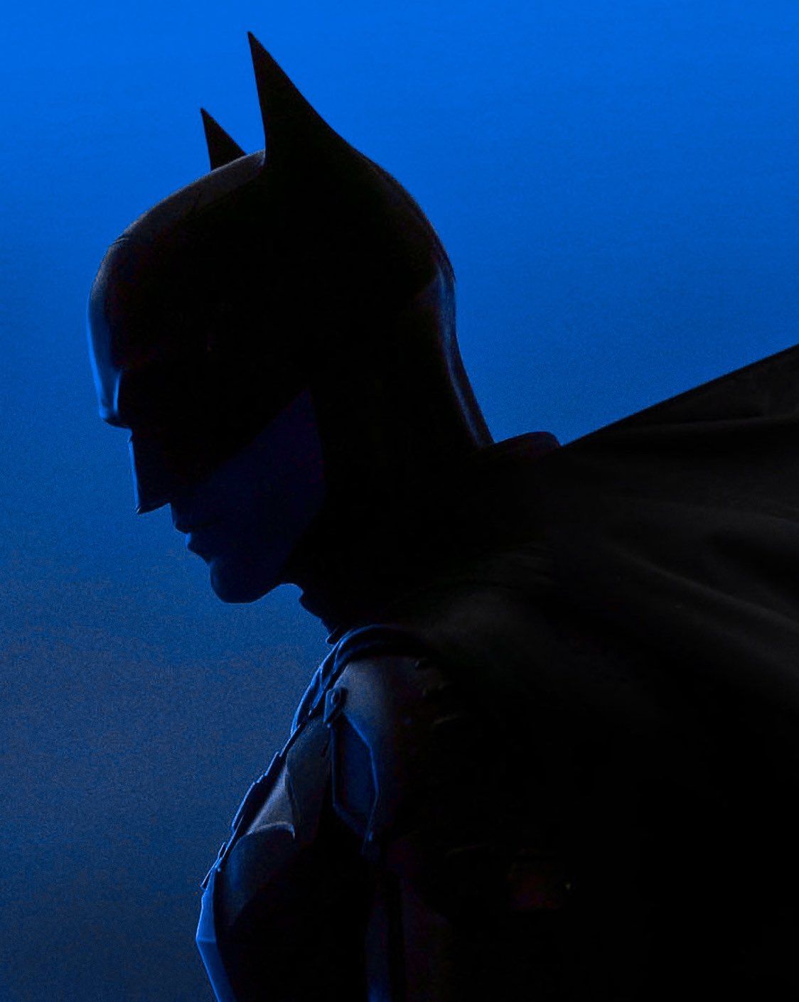 The silhouette of the Batman against a blue background - Batman