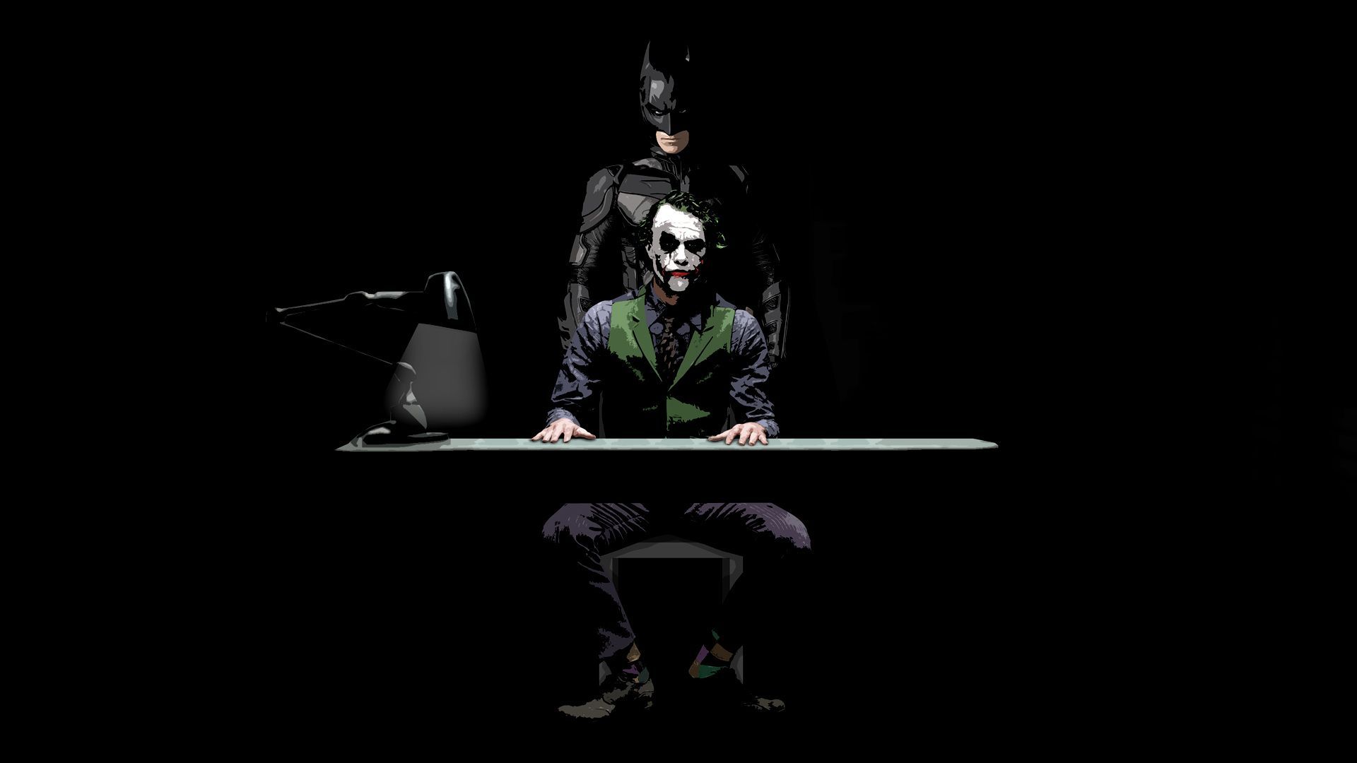 The joker sitting at a desk in front of an image - Batman