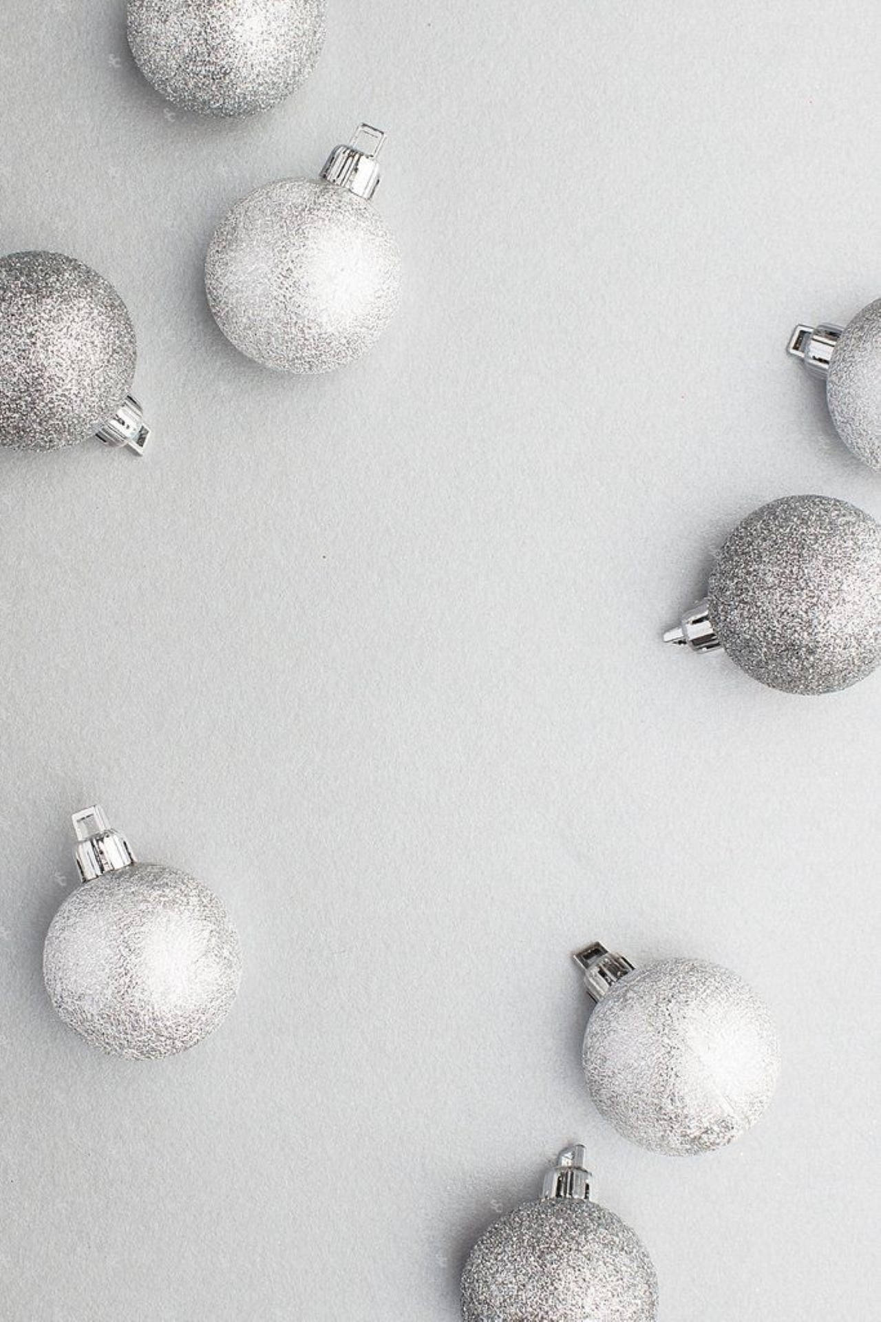 A bunch of silver and white ornaments on the ground - Silver