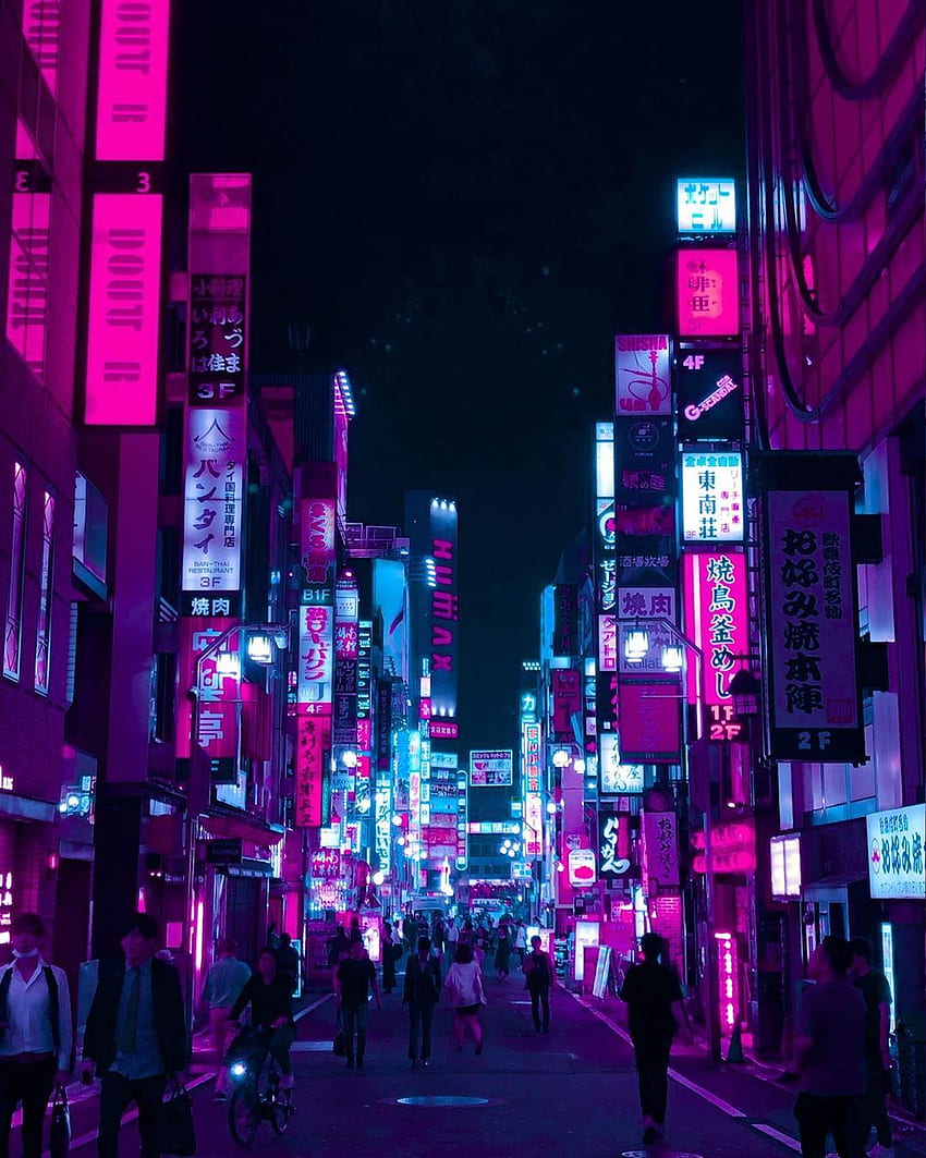 A busy street at night with neon lights - Tokyo