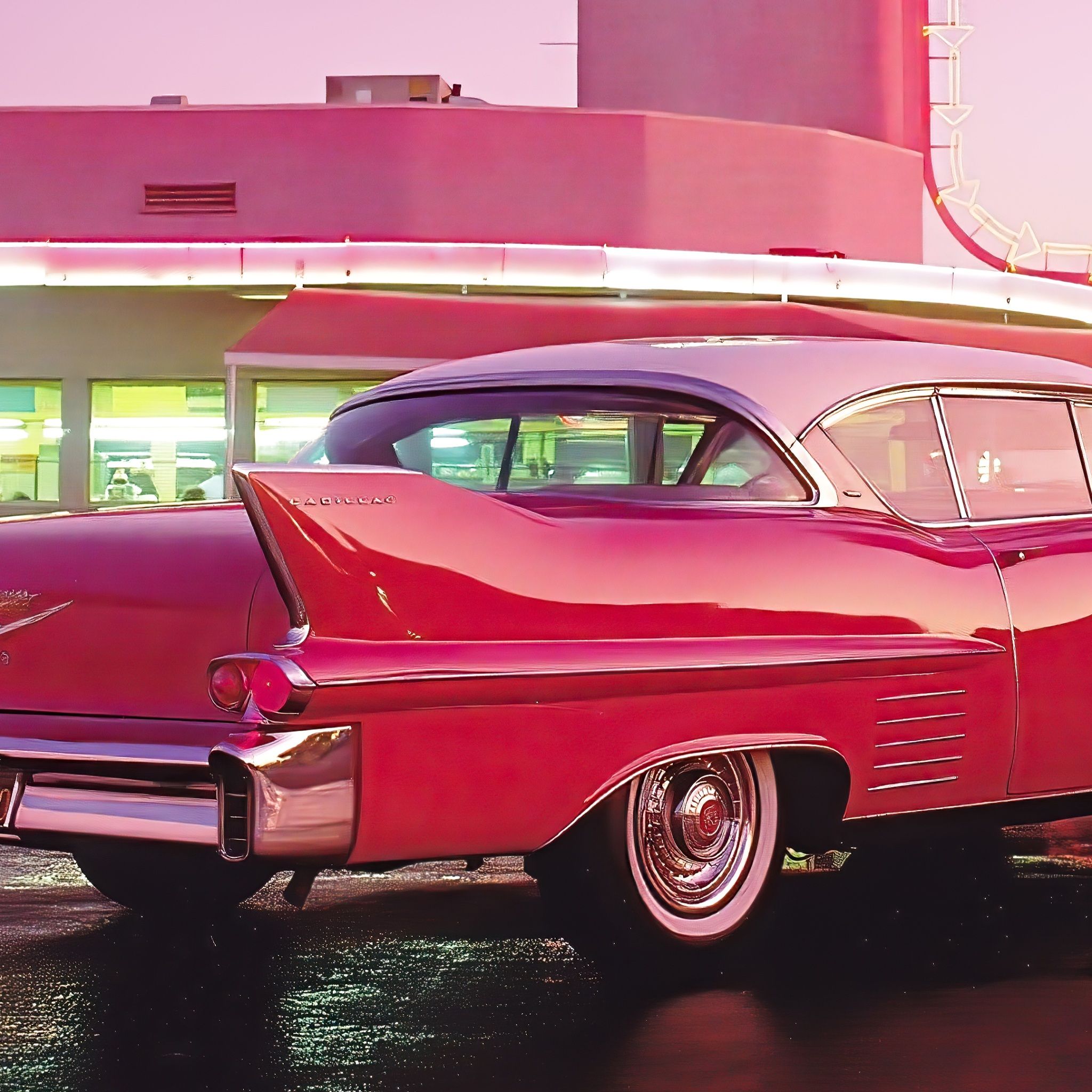 A red 1950s car parked outside a diner - 50s