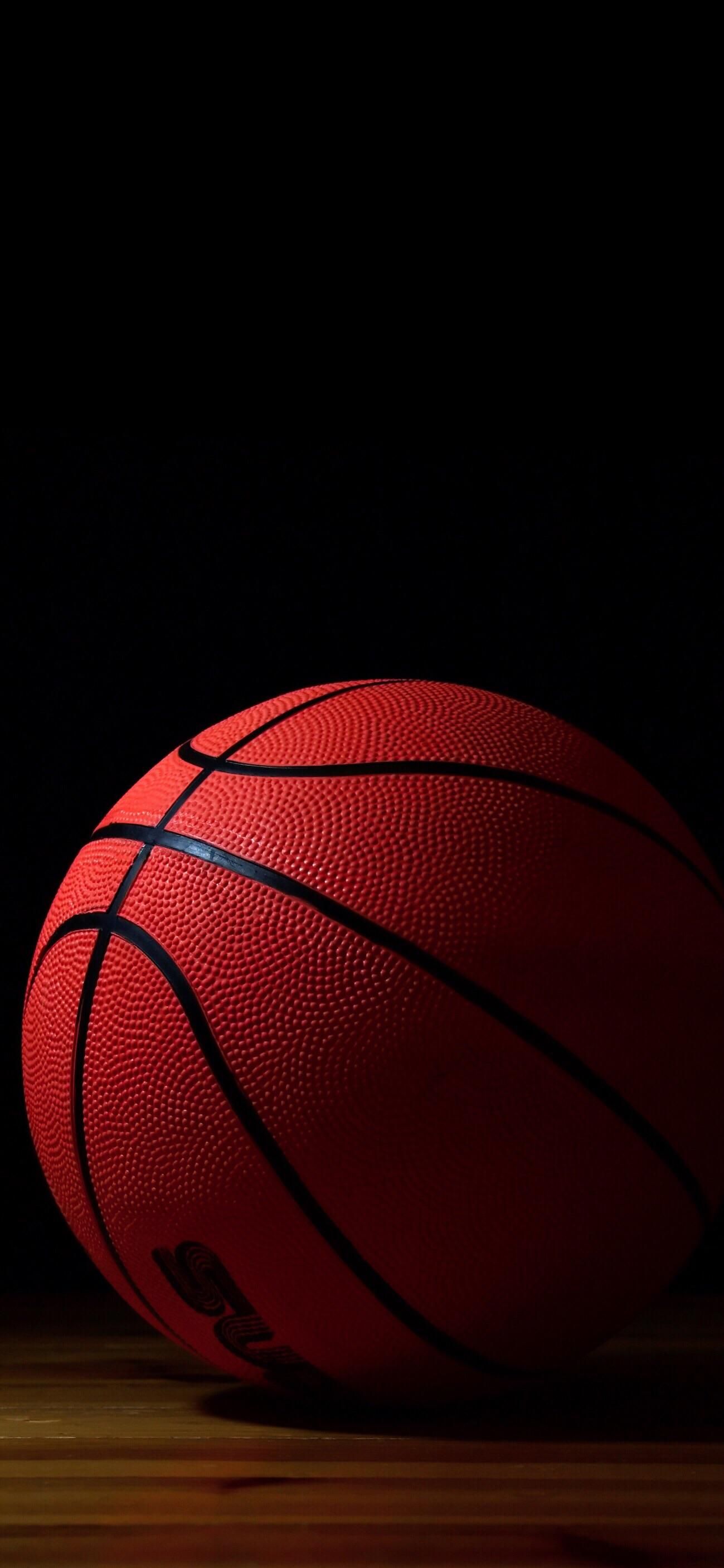 A basketball sitting on top of the floor - Basketball