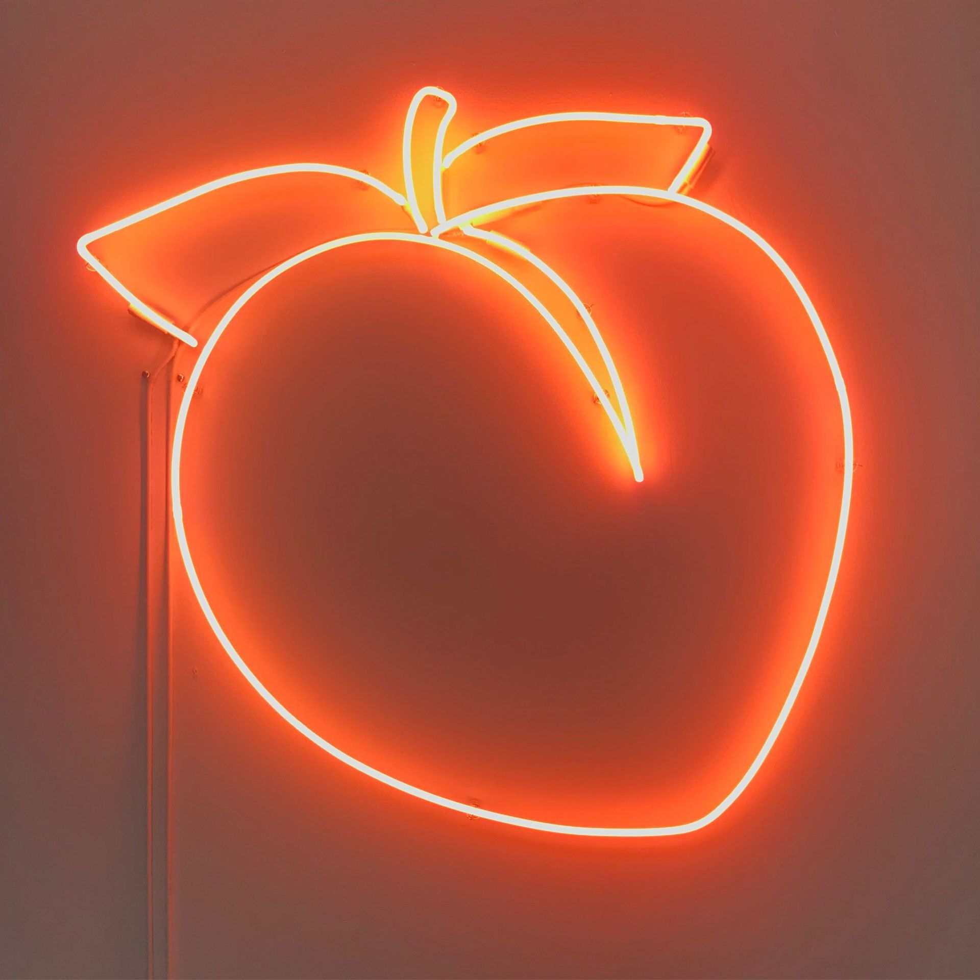 A neon light with an orange peach on it - Neon orange