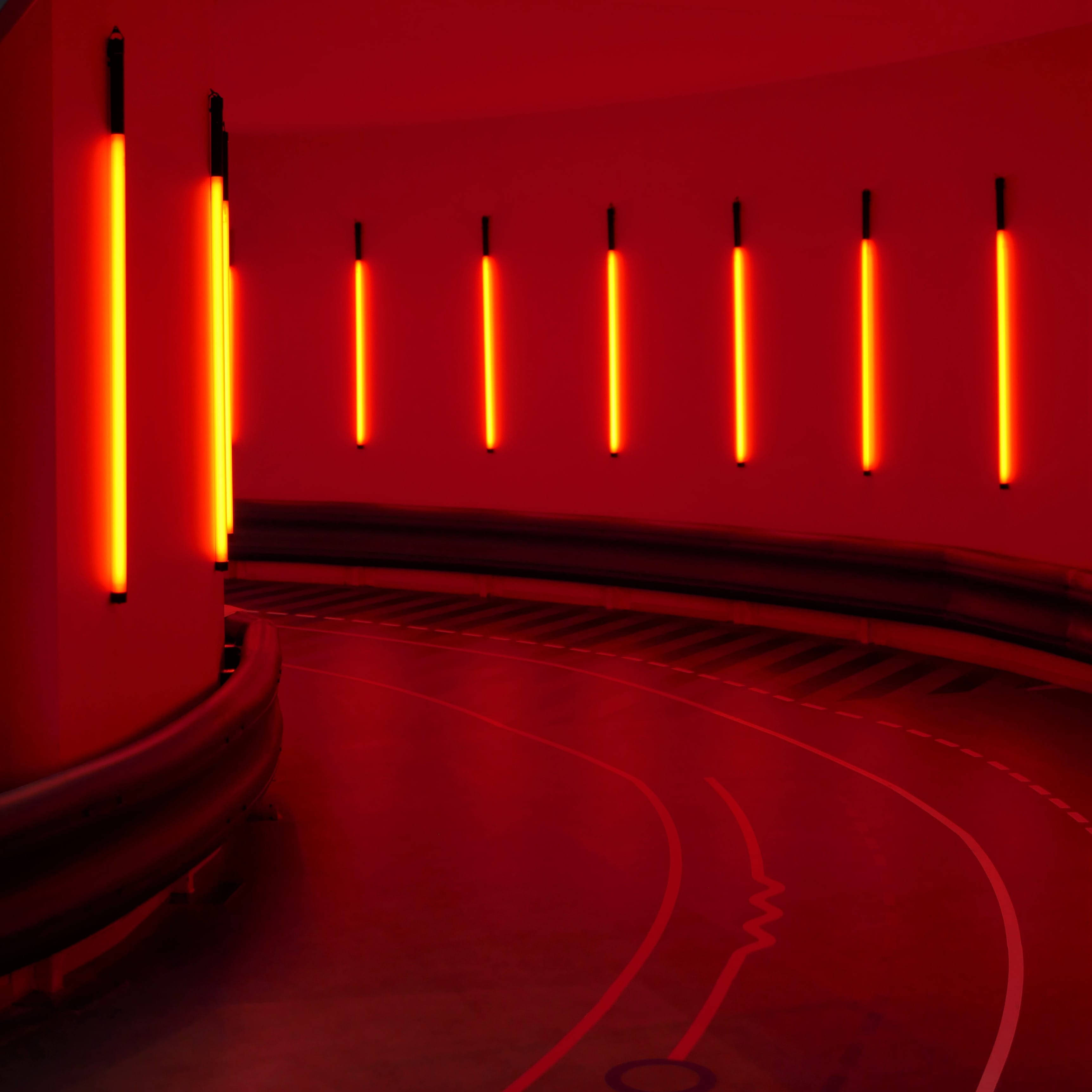 A red room with many lights on the wall - Neon orange