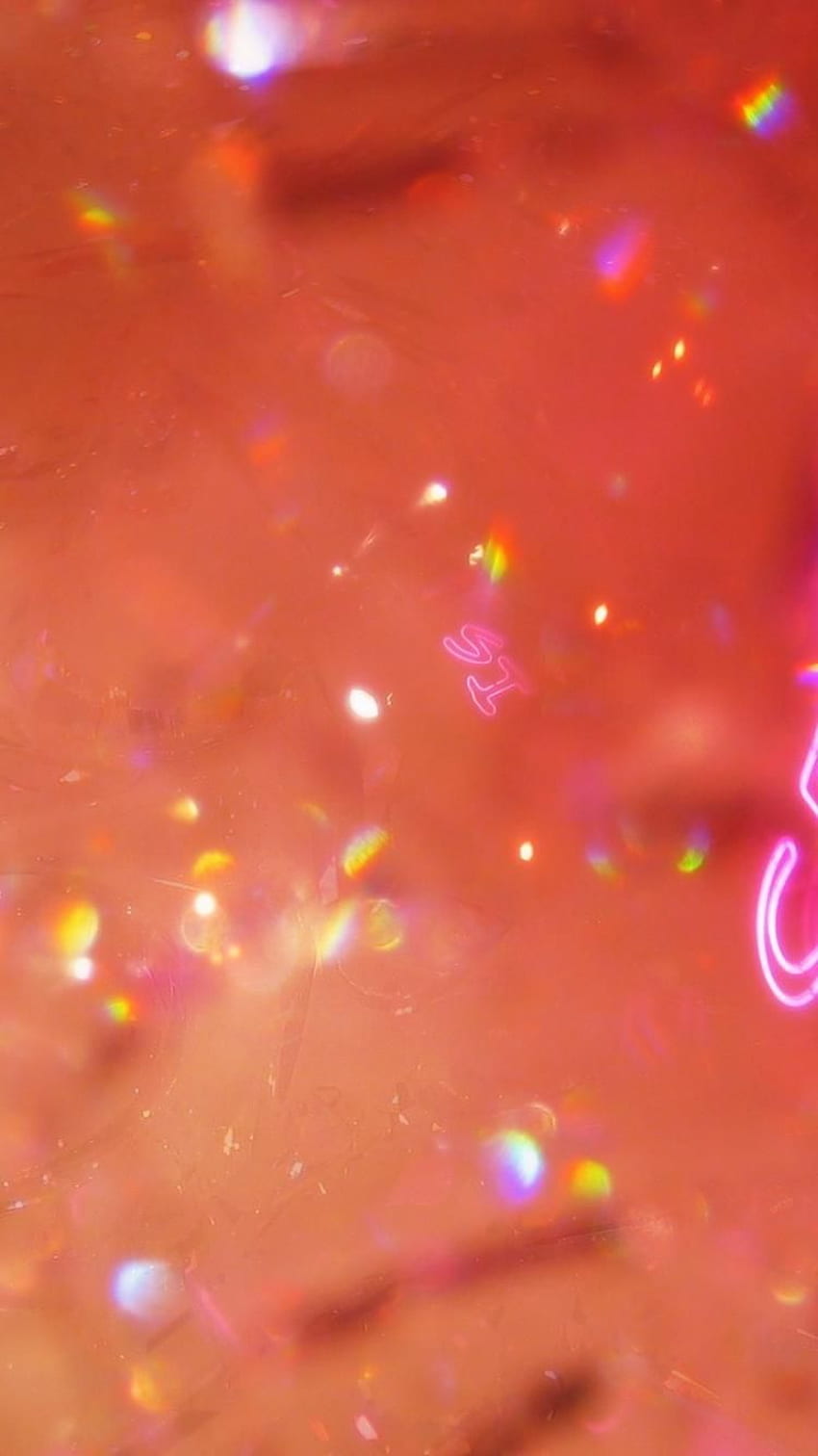 A close up of a pink wall with rainbow lights shining on it - Neon orange