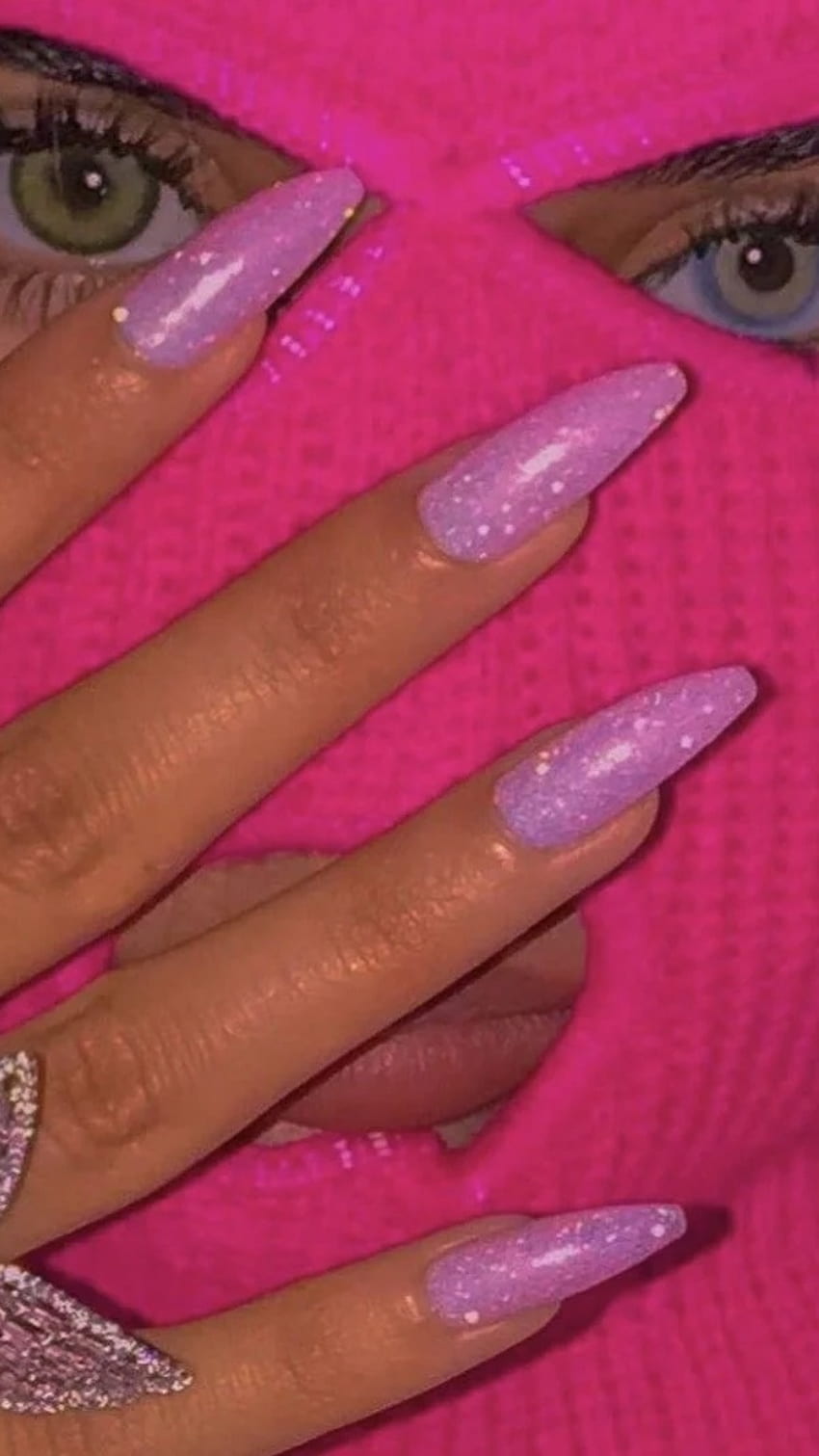 A woman with long nails and a pink sweater - Nails