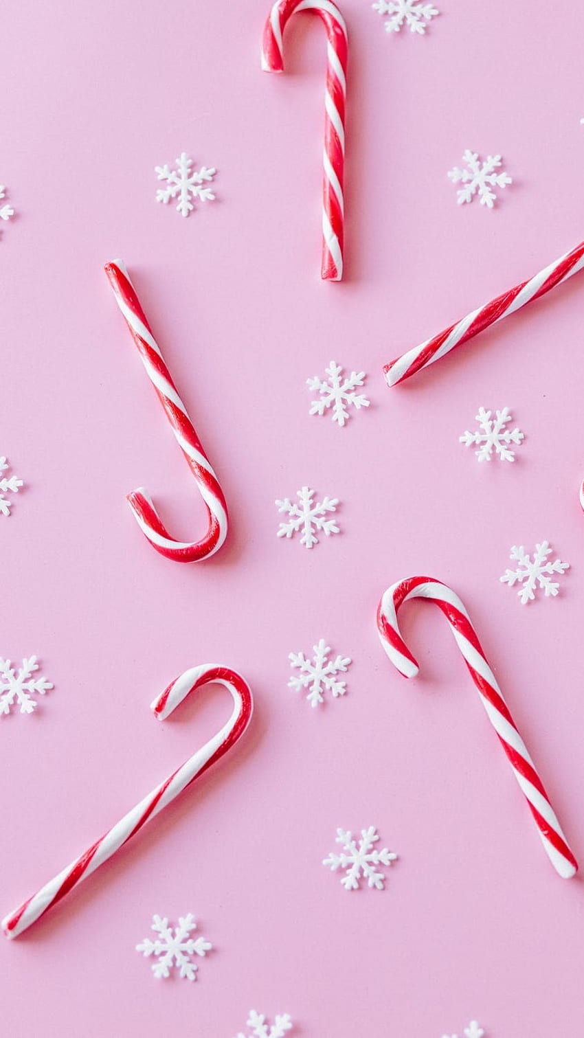 Candy canes and snowflakes on a pink background - Candy cane