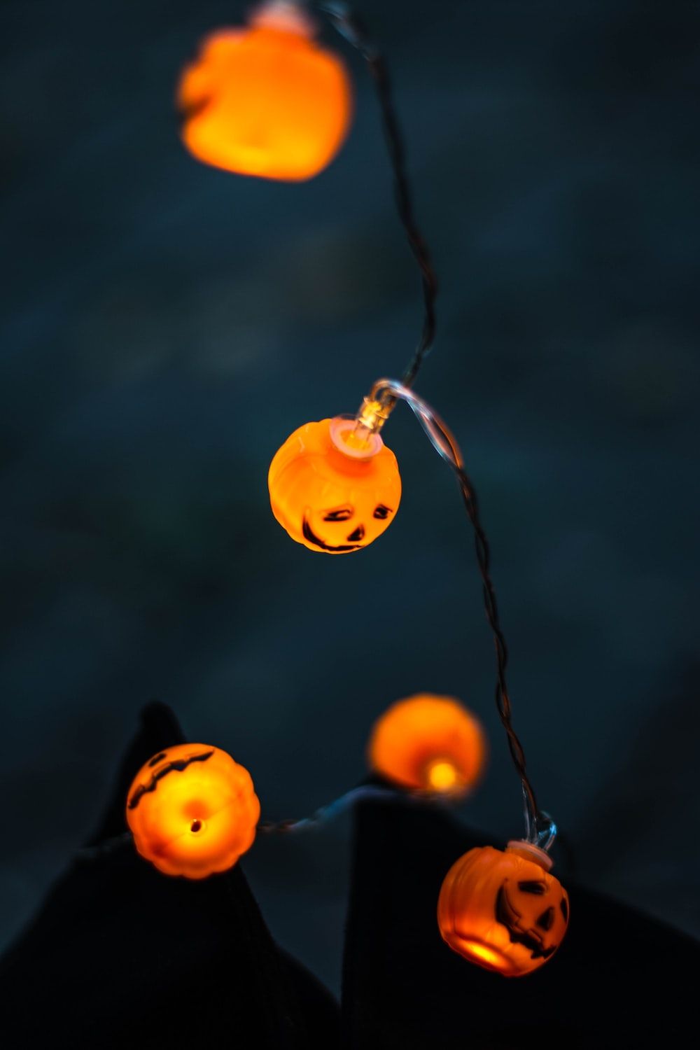 String lights in the shape of pumpkins with faces on them - Halloween, cute Halloween, spooky