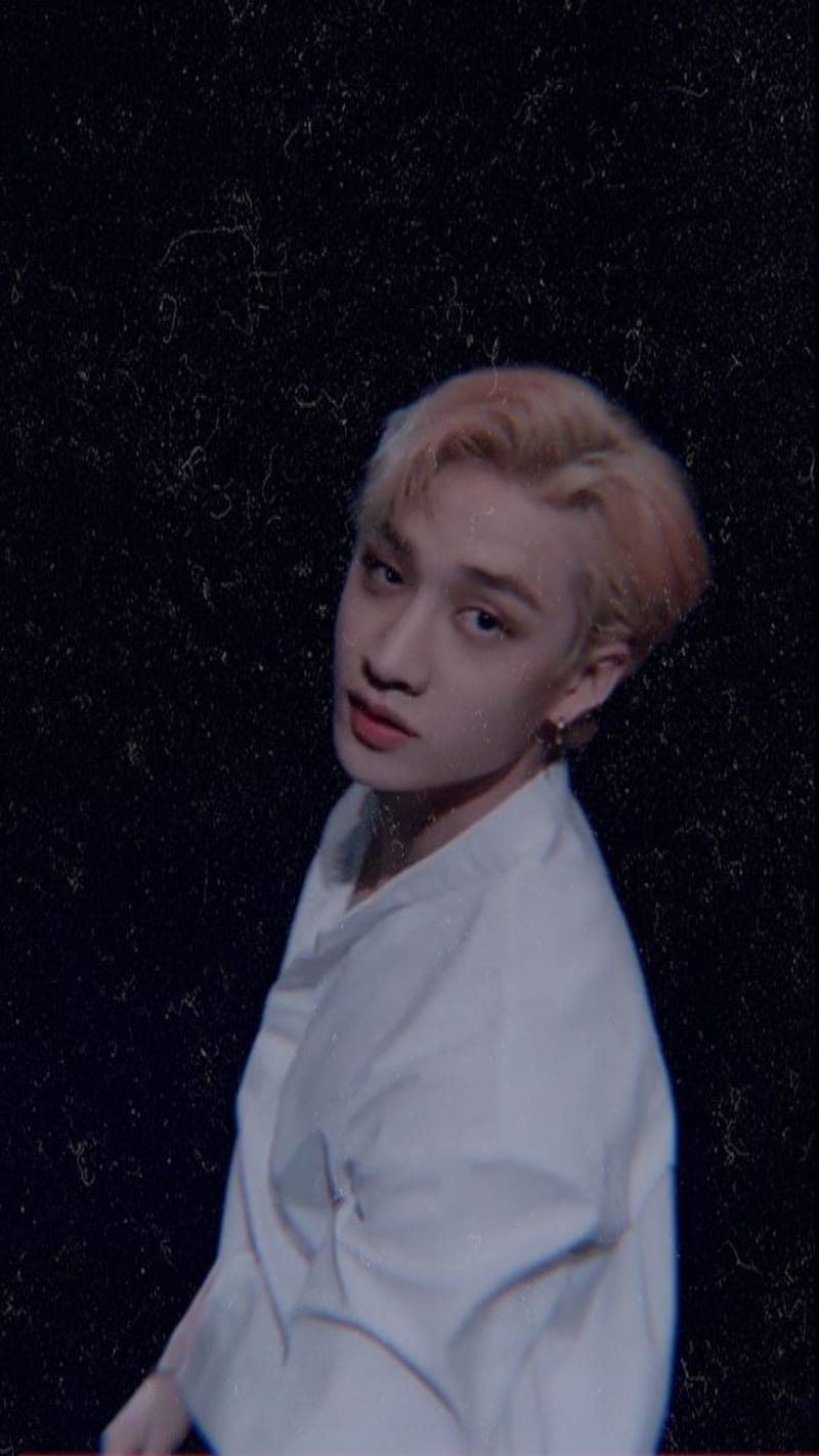 A person with blonde hair and white shirt - Bang Chan