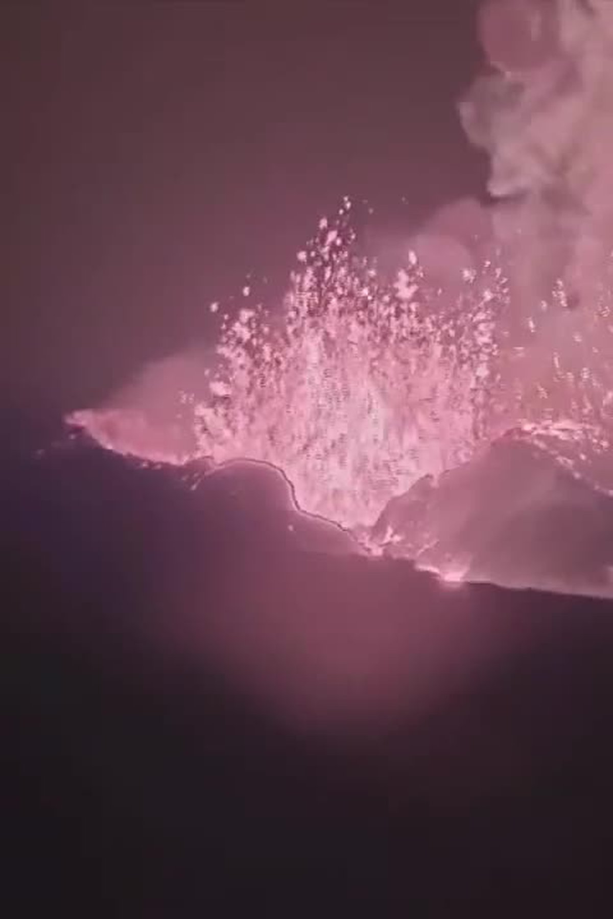 A volcano erupts in the night sky - Bling