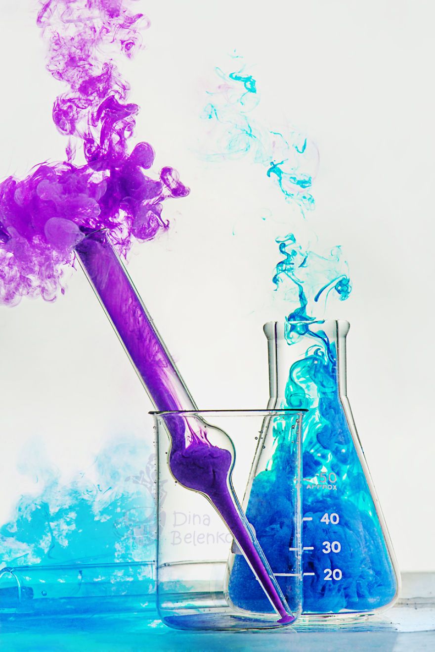 A purple liquid is being poured into two beakers - Chemistry