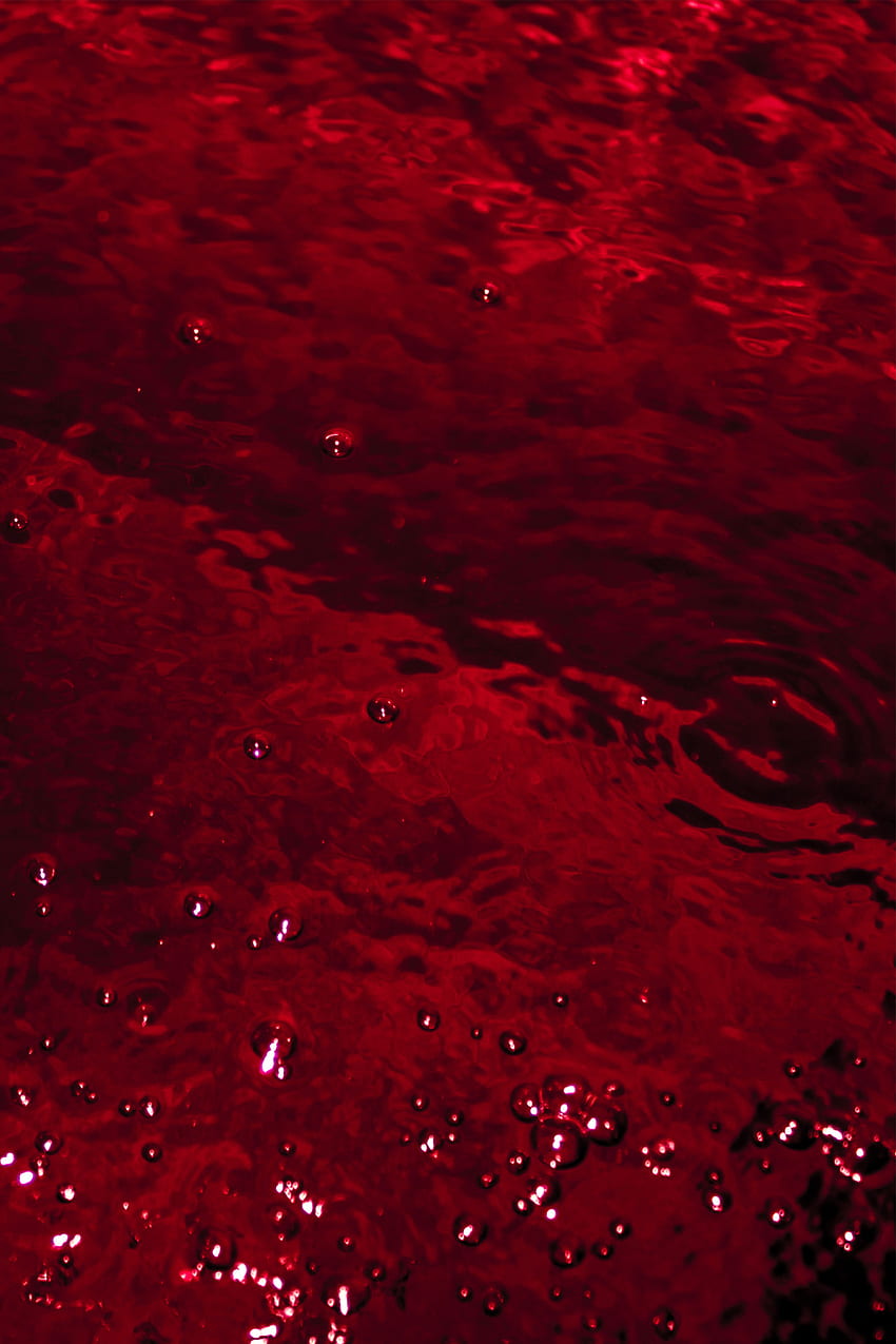 A red apple floating in water with bubbles - Dark red, crimson