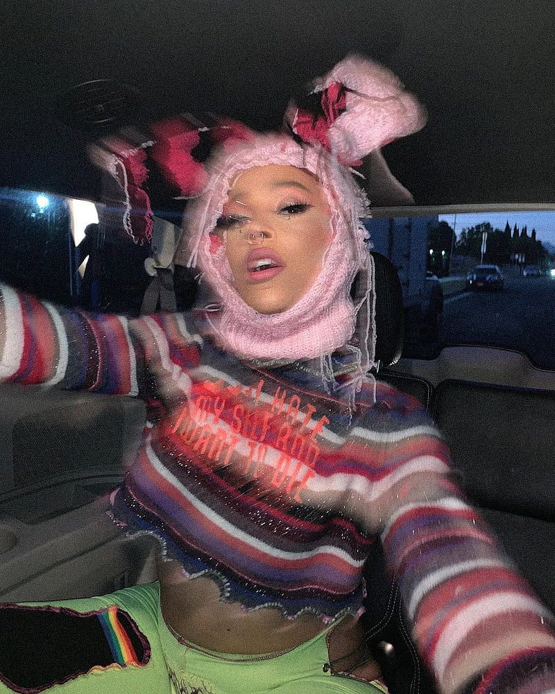 A woman in the back of her car - Doja Cat
