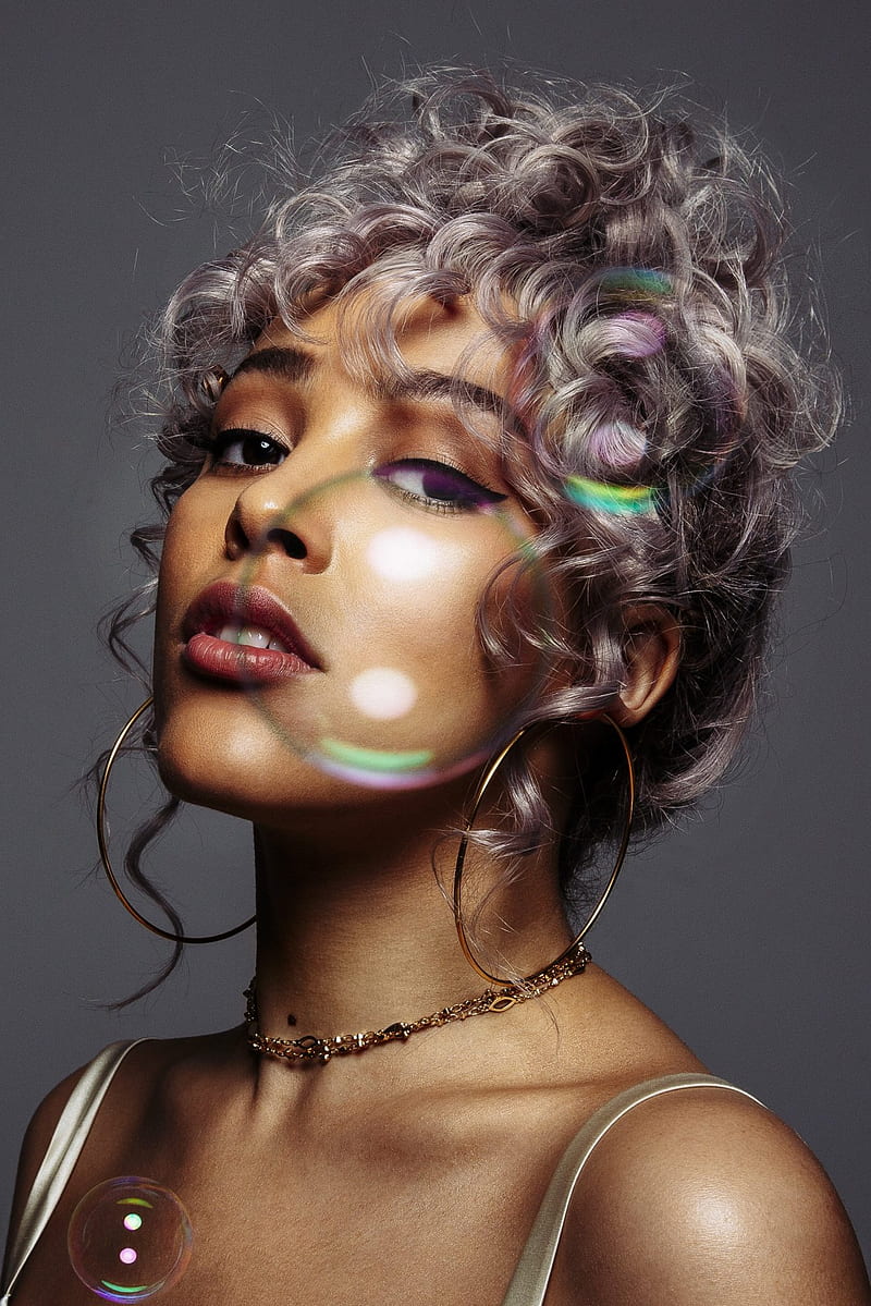 A woman with gray hair and bubbles - Doja Cat