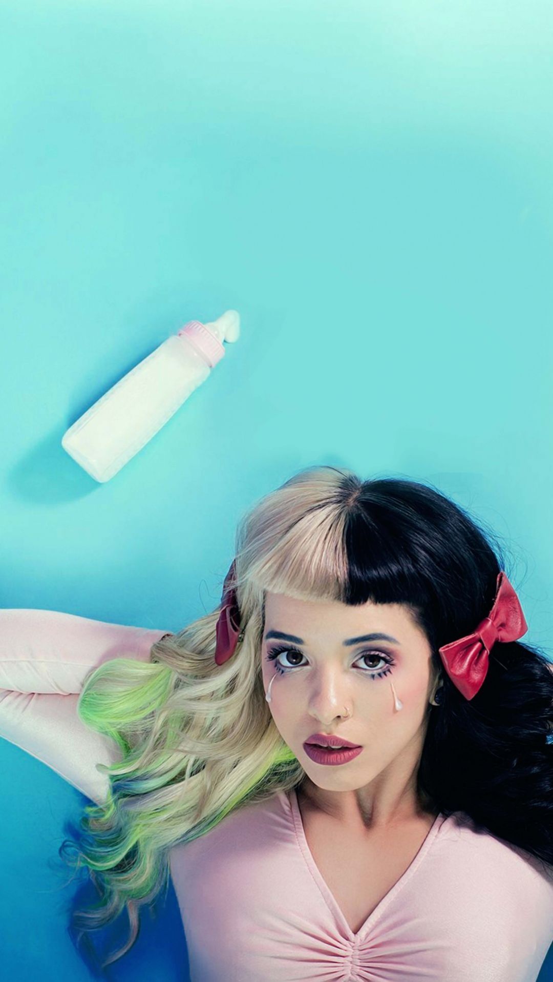 Wallpaper for iPhone of a woman with a bow tie and a baby bottle - Melanie Martinez