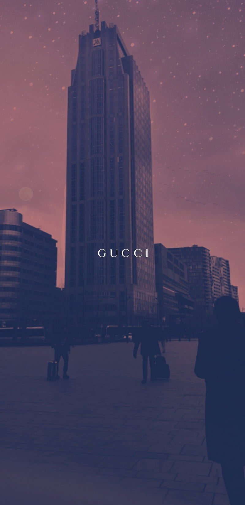 A man is walking in front of some buildings - Gucci