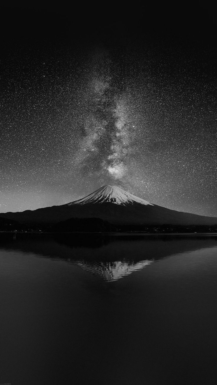 A black and white photo of the milky way over mount fuji - Black