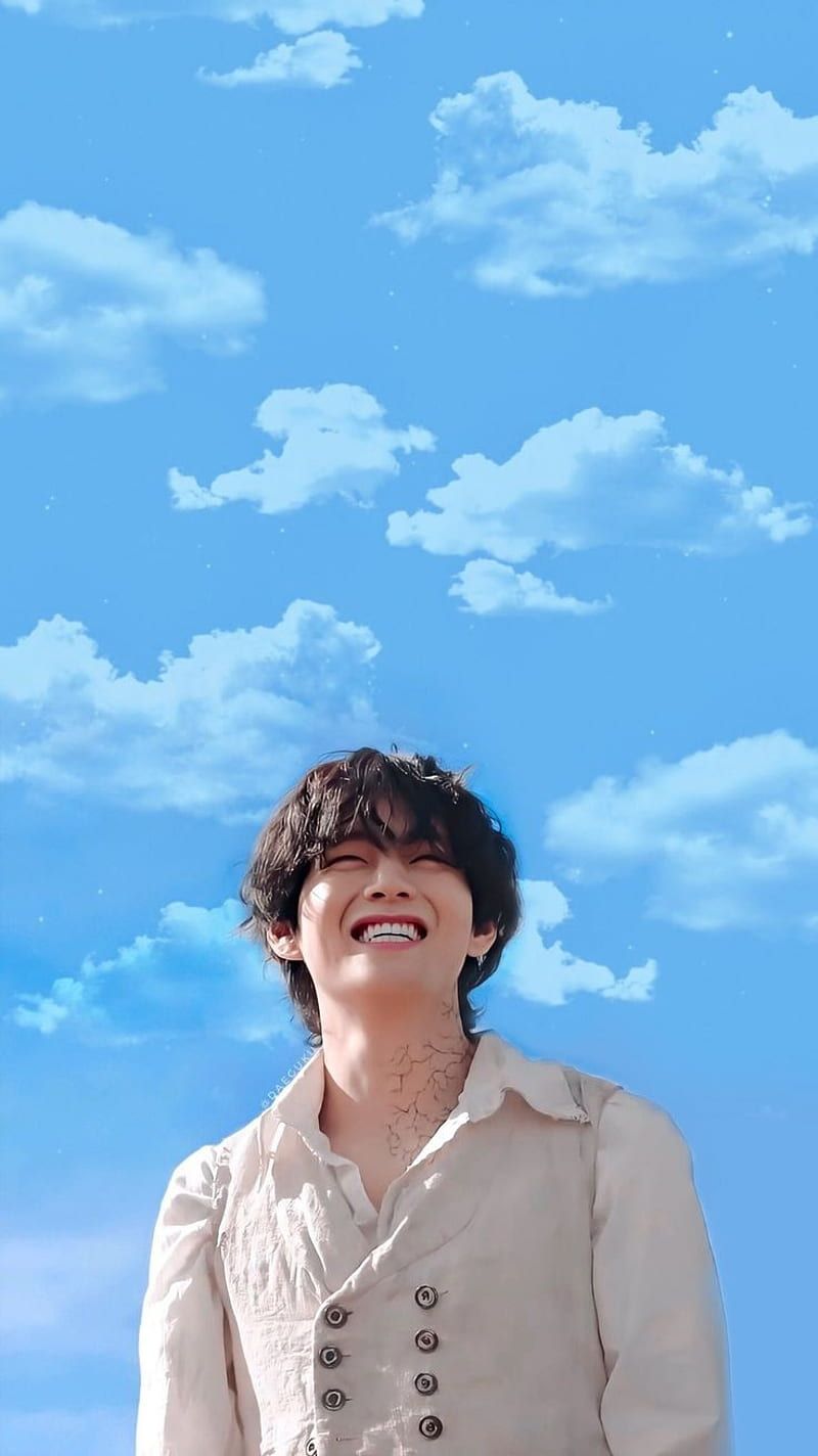 A man in white standing next to clouds - BTS
