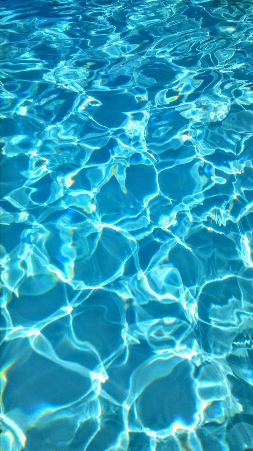 The sun reflects off the surface of a pool. - Water