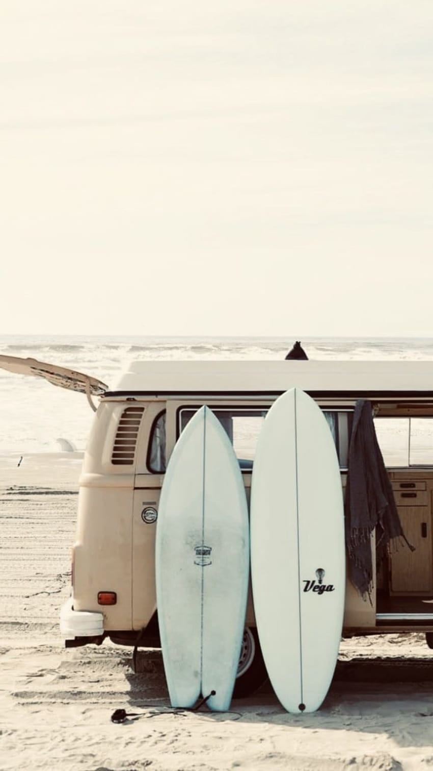 A van with surfboards on the beach - Surf