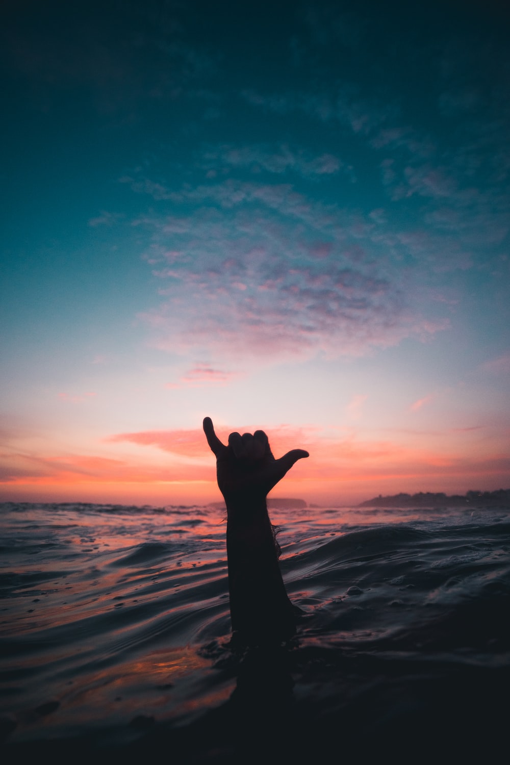 Silhouette of person standing on the beach during sunset - Surf