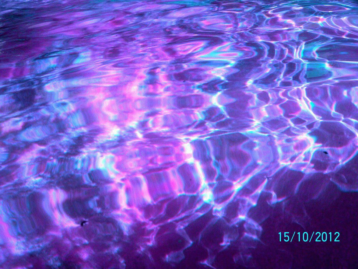 A purple and blue water is seen in the background - Indigo