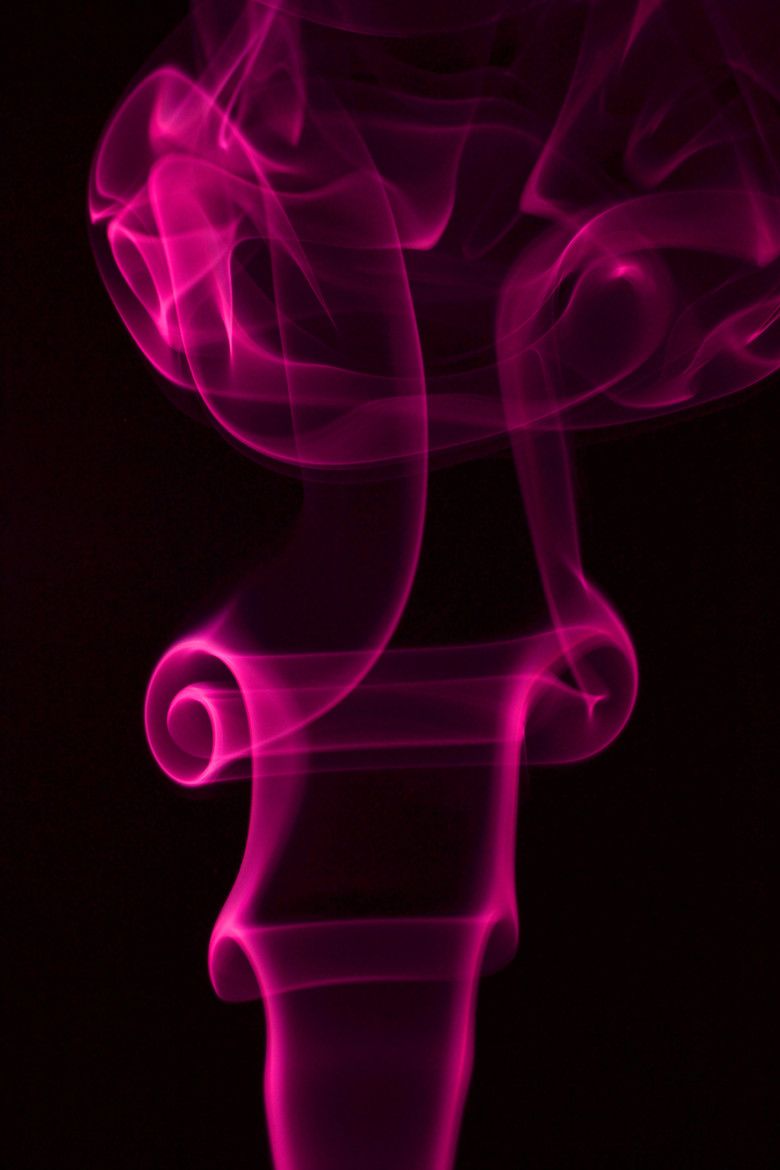 Smoke in the air with a black background - Magenta