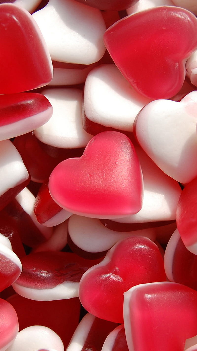 A pile of red and white heart shaped candies. - Candy