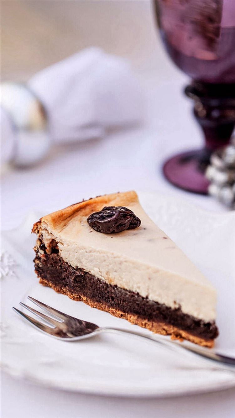 A slice of cheesecake on top is sitting - Chocolate