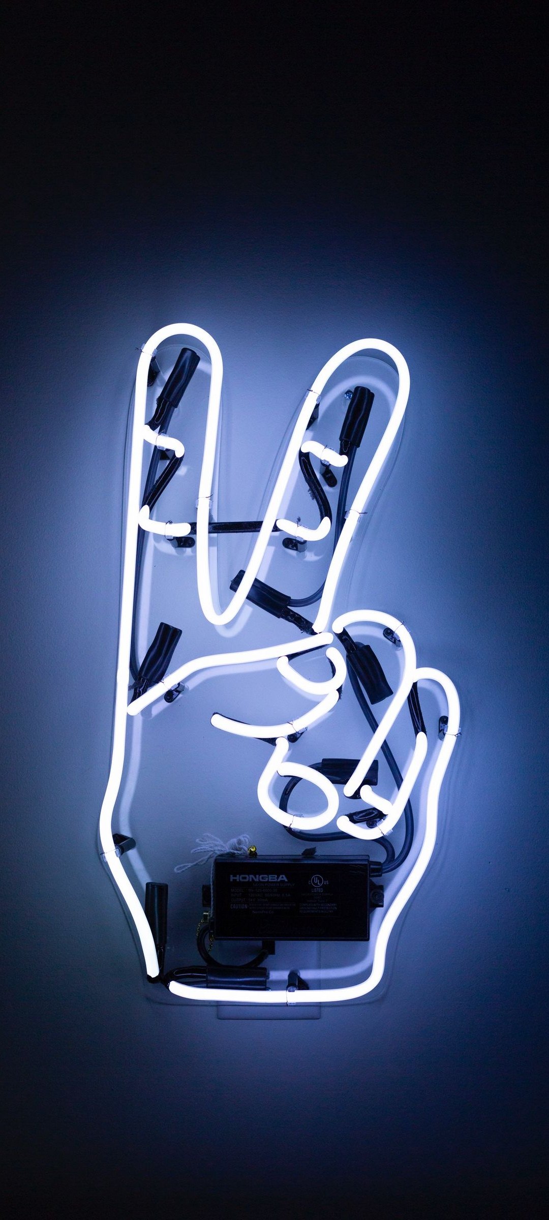 A neon sign with the peace symbol - Peace