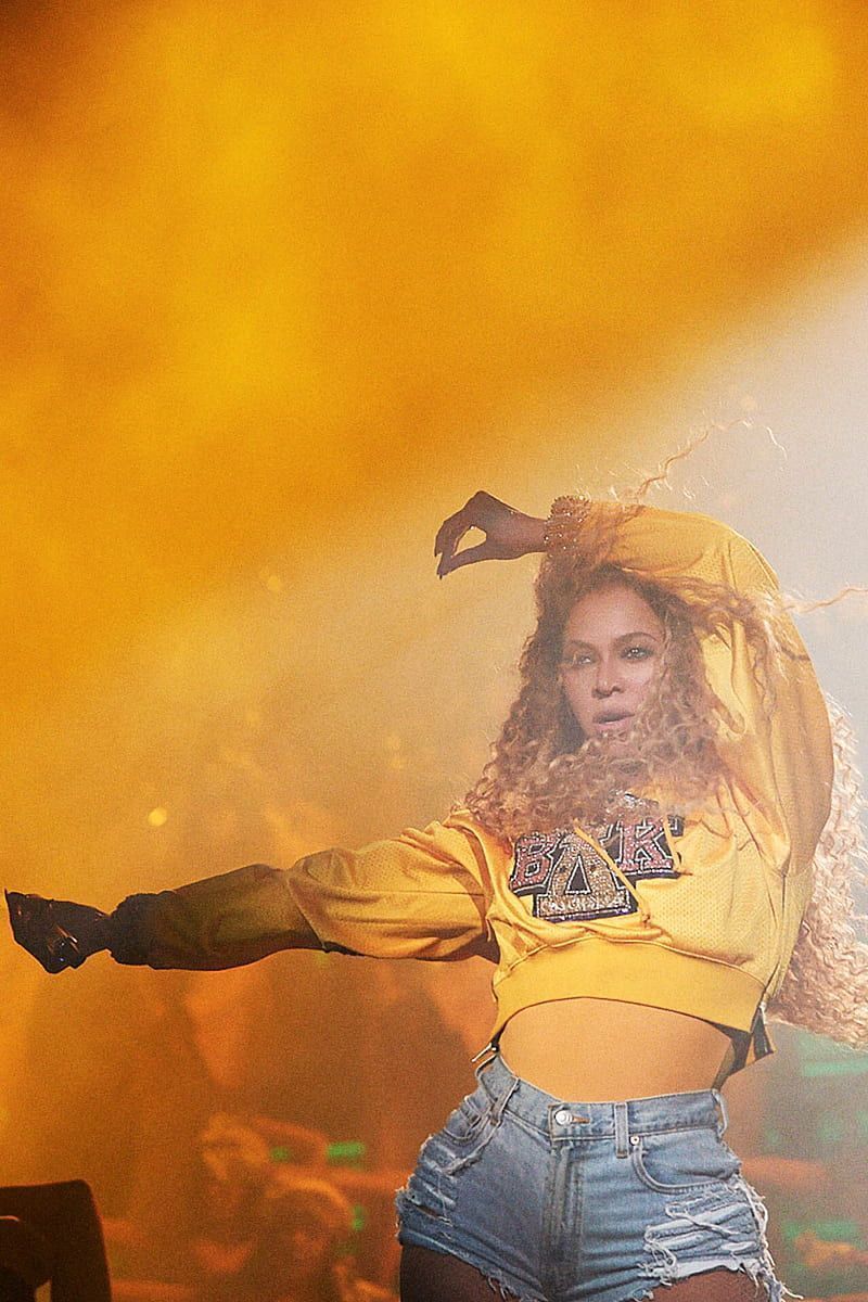 A woman in yellow shirt and jeans - Beyonce